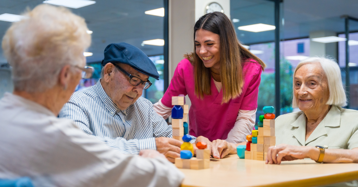 A caregiver and seniors sitting at a table