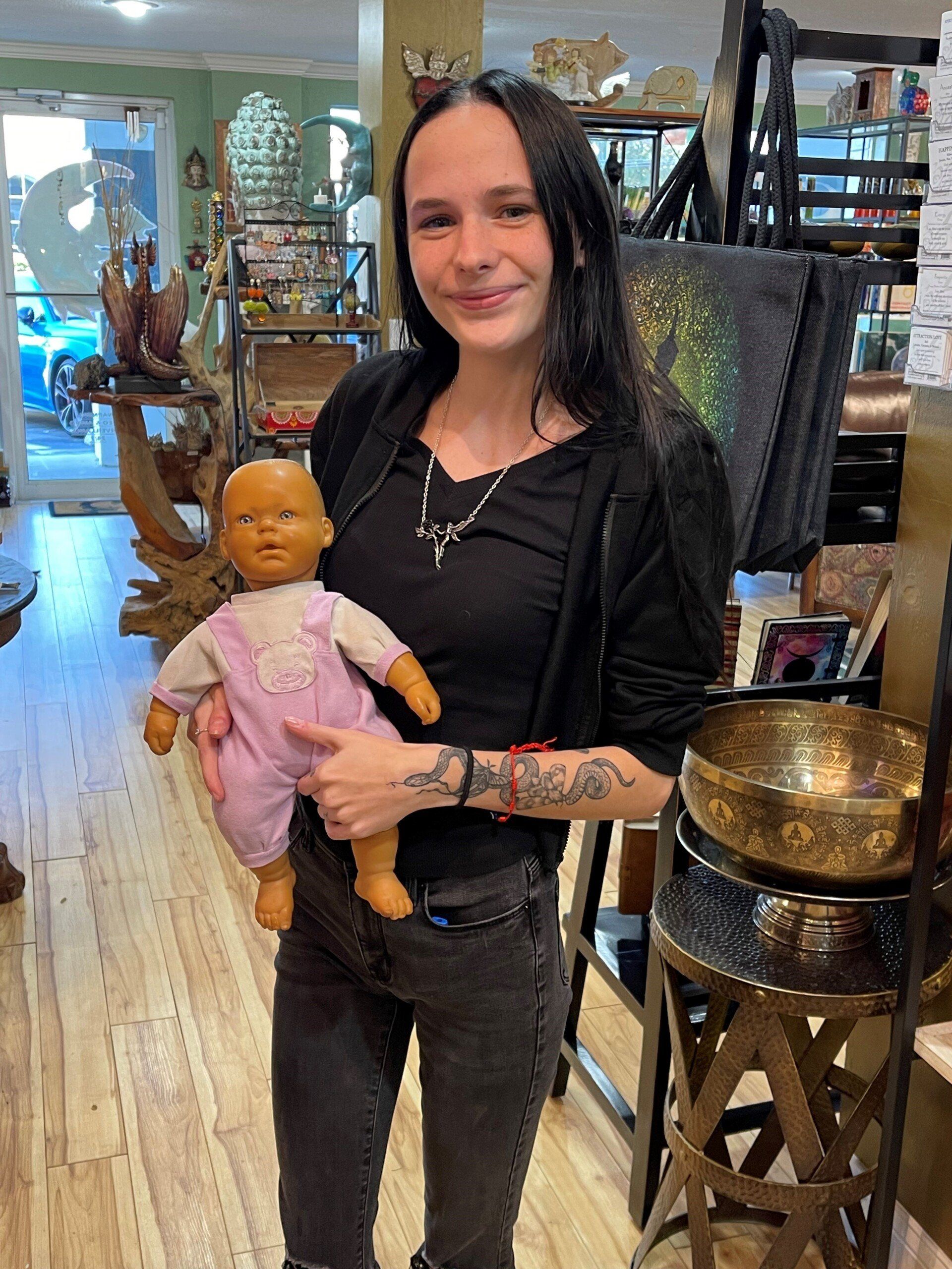 Woman Holding A Doll — Tampa, FL — Antique Restoration and Design