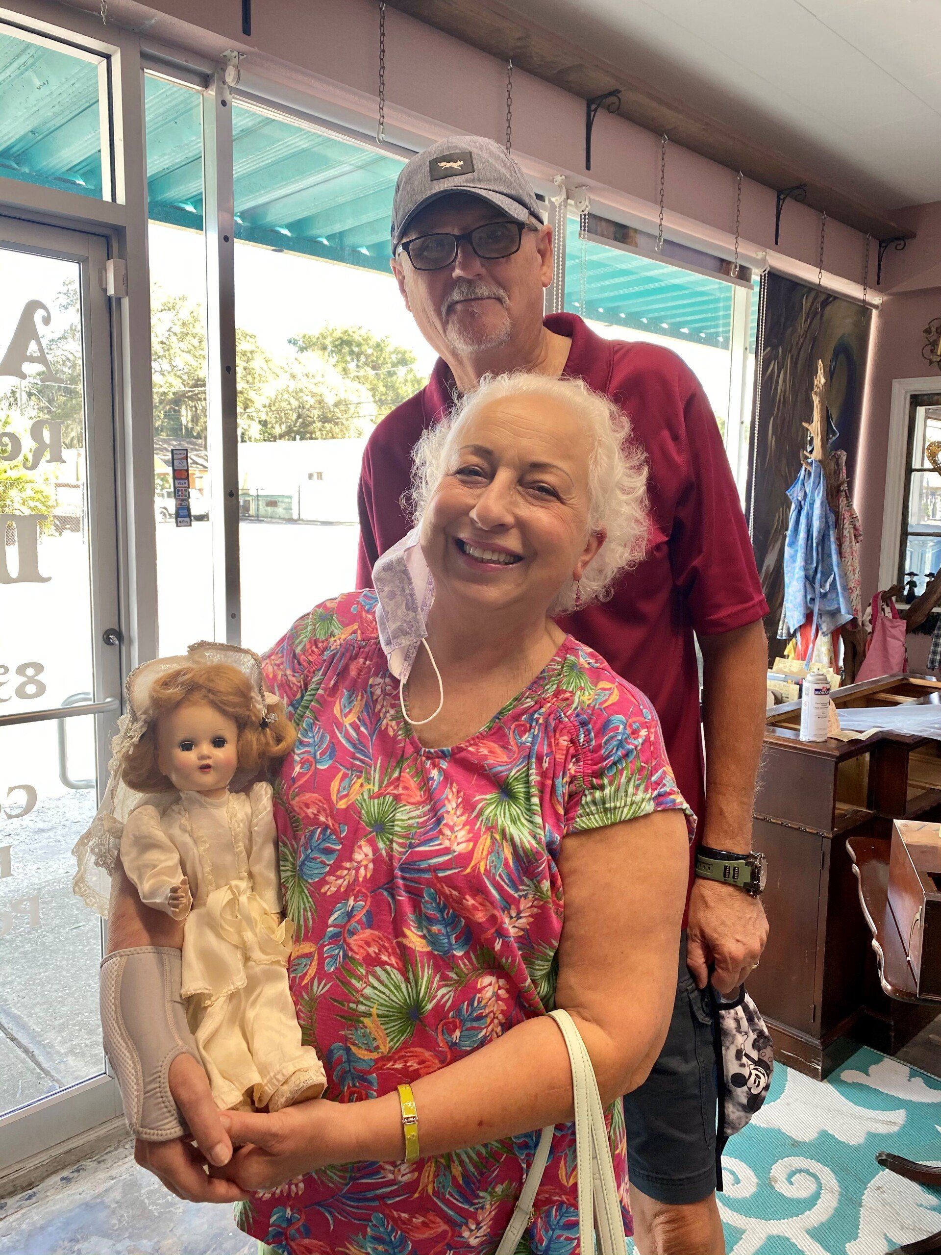 Smiling Woman Carrying A Doll — Tampa, FL — Antique Restoration and Design