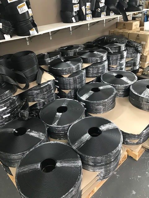 A warehouse filled with lots of rolls of black tape
