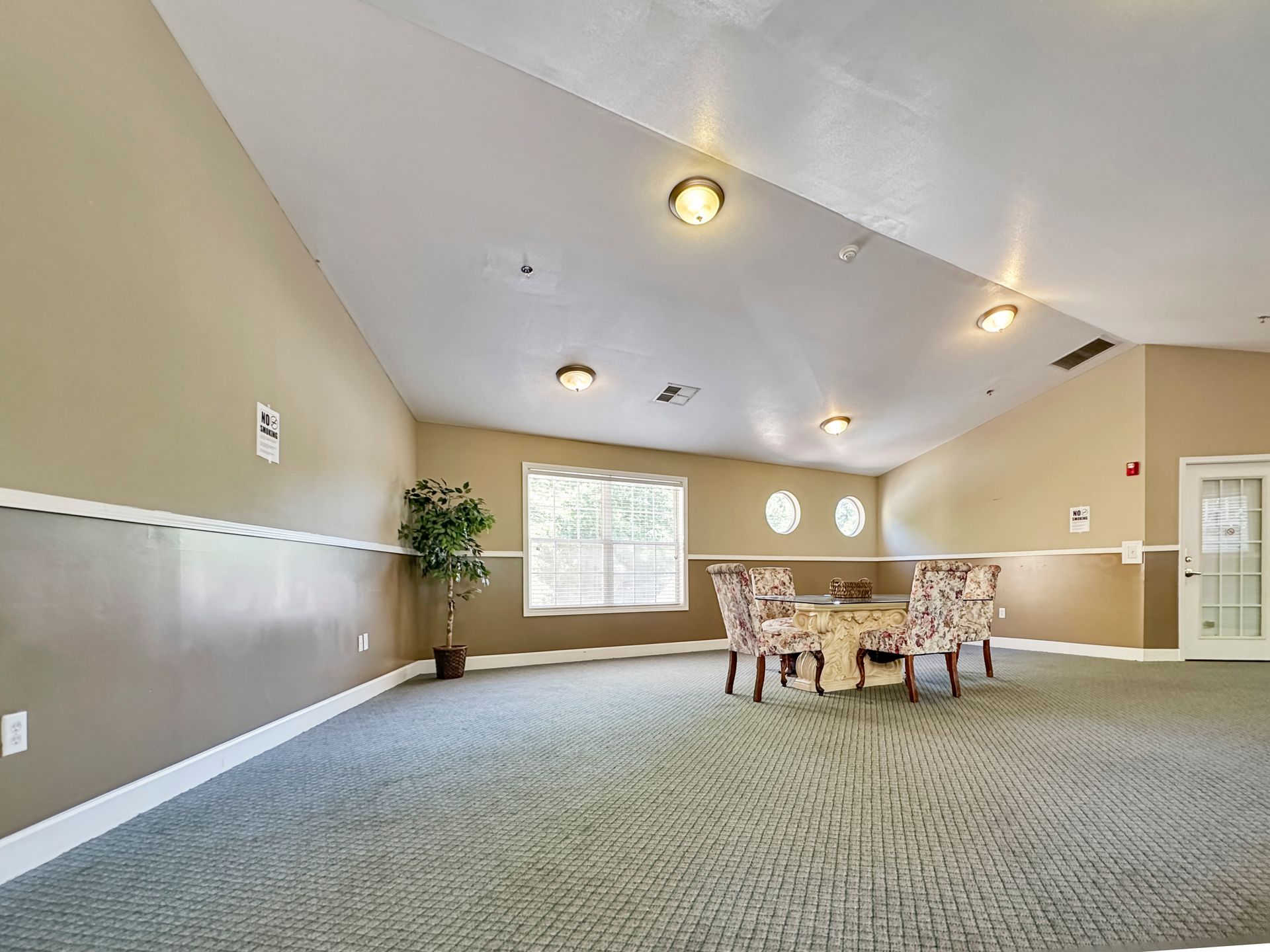 A large room with a table and chairs in it