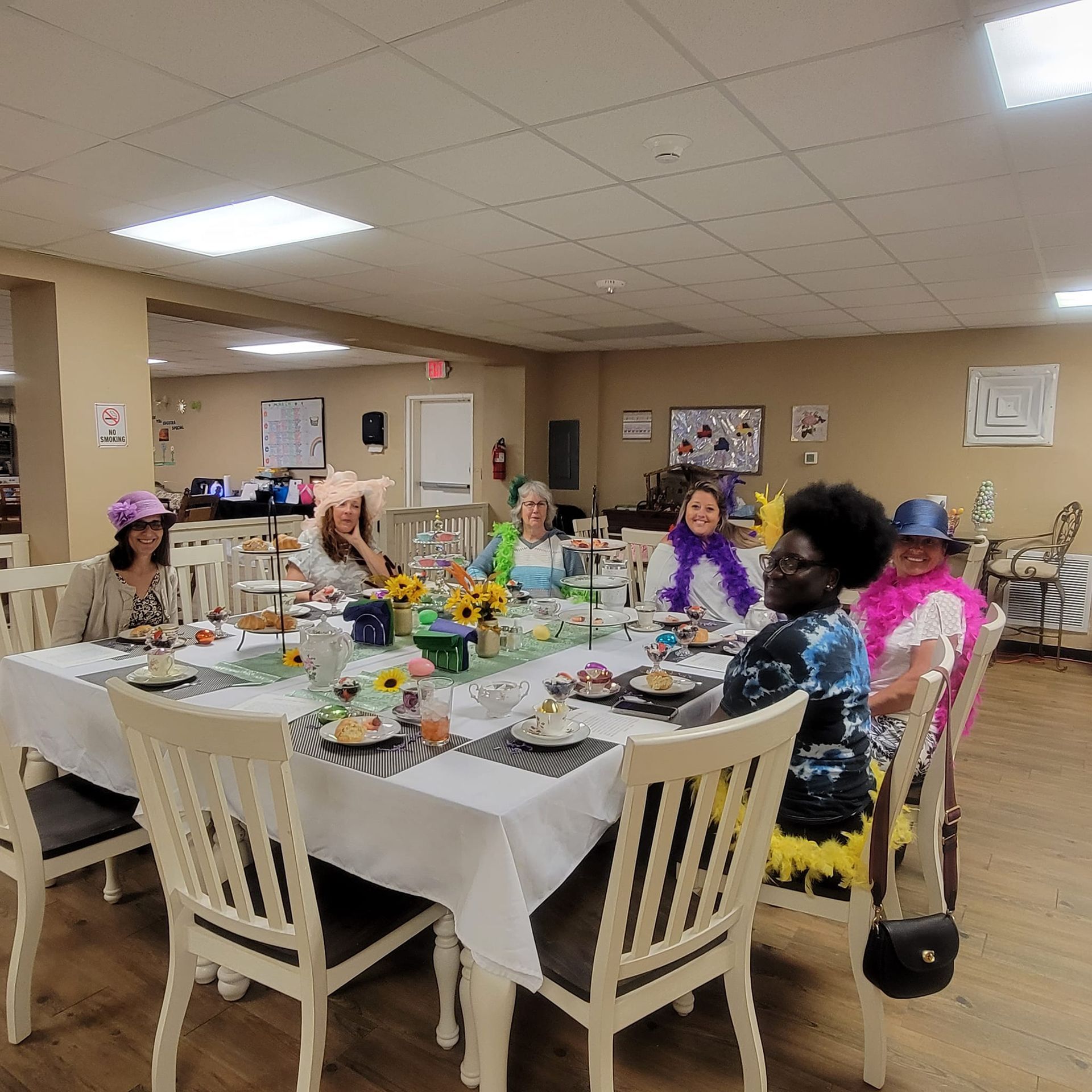 A group of people are sitting around a table with plates of food.