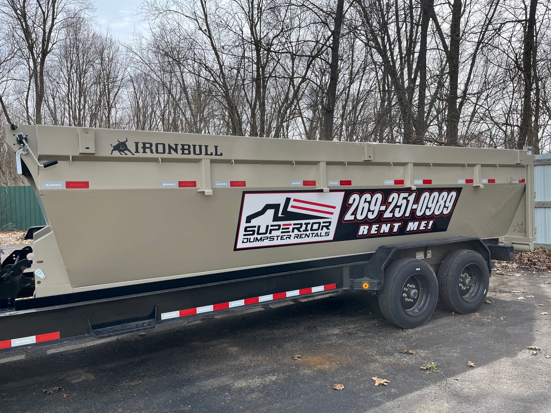 Superior Dumpster Rentals roll-off dumpster trailer parked on a driveway