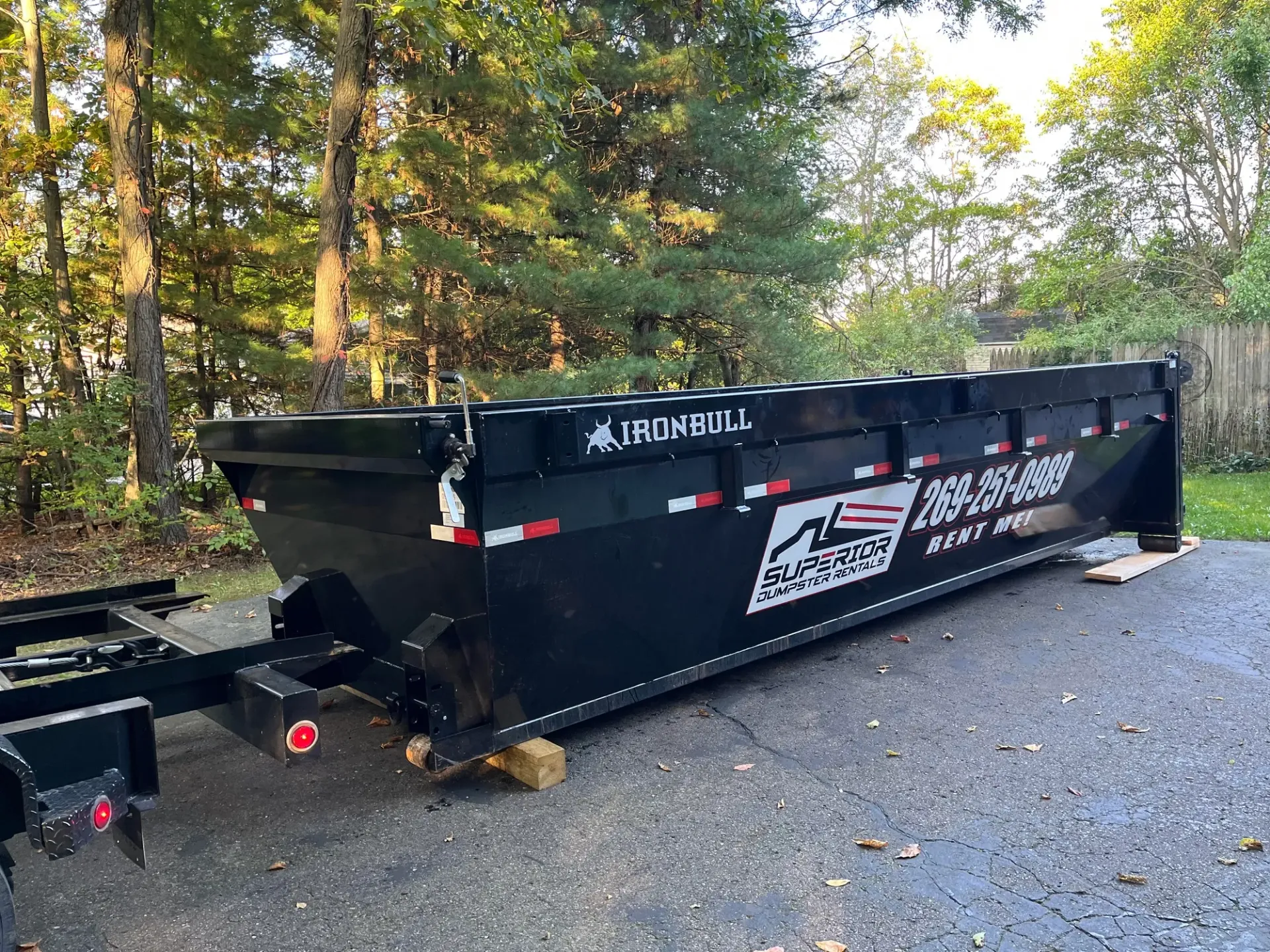 Black dump trailer parked outside.