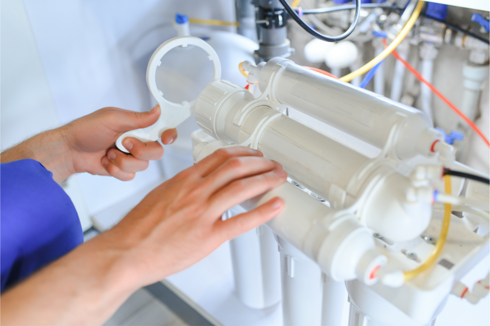 Person using a tool to service a white water filtration system.