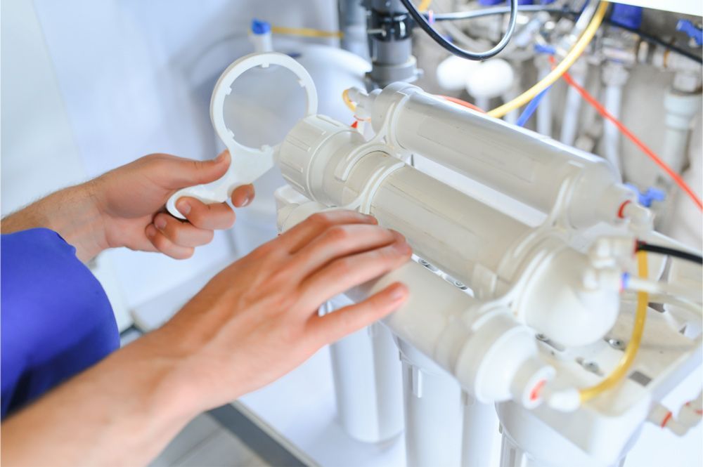 Person using a tool to service a white water filtration system. Person using a tool to service a white water filtration system.