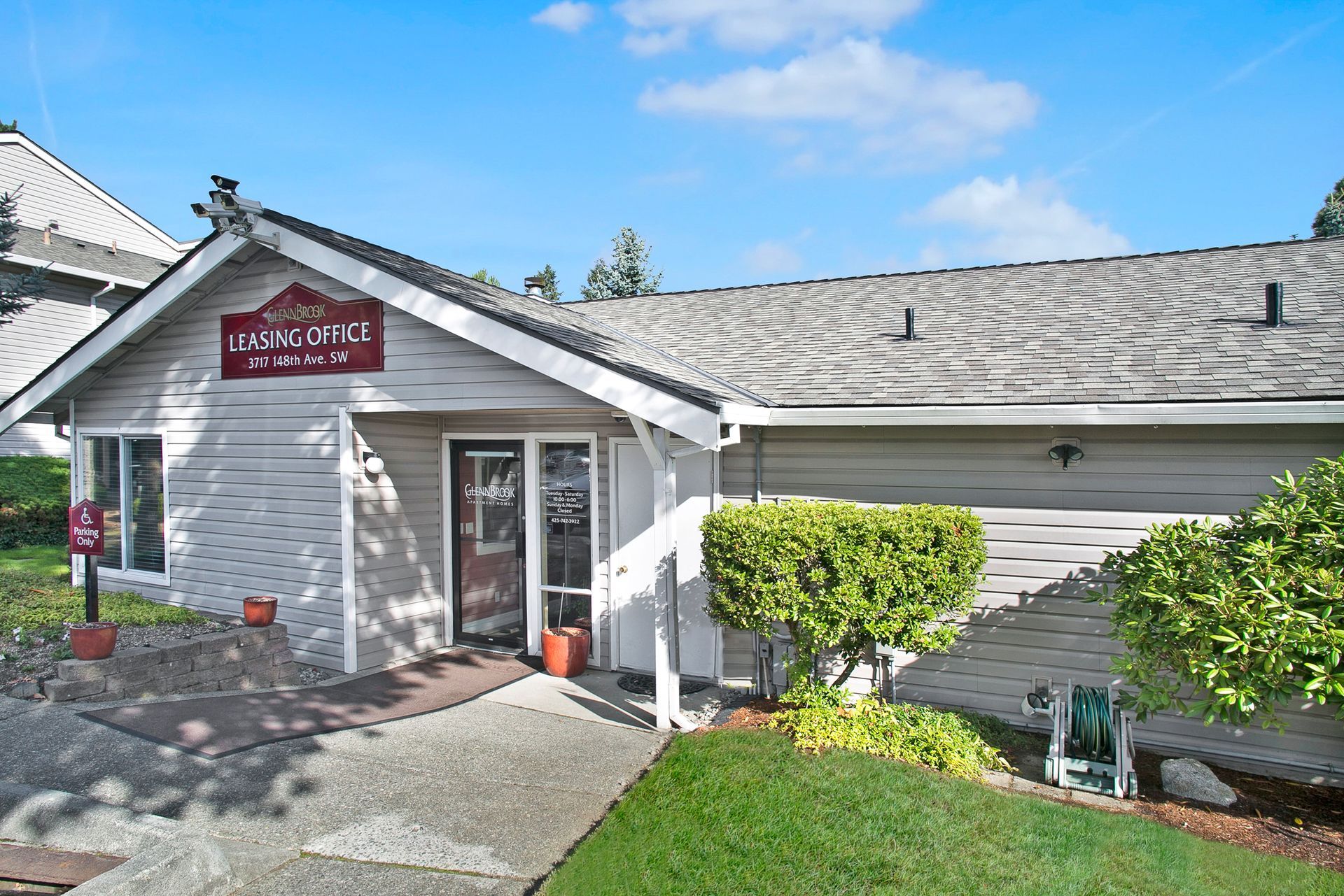 A white house with a red sign on the front of it