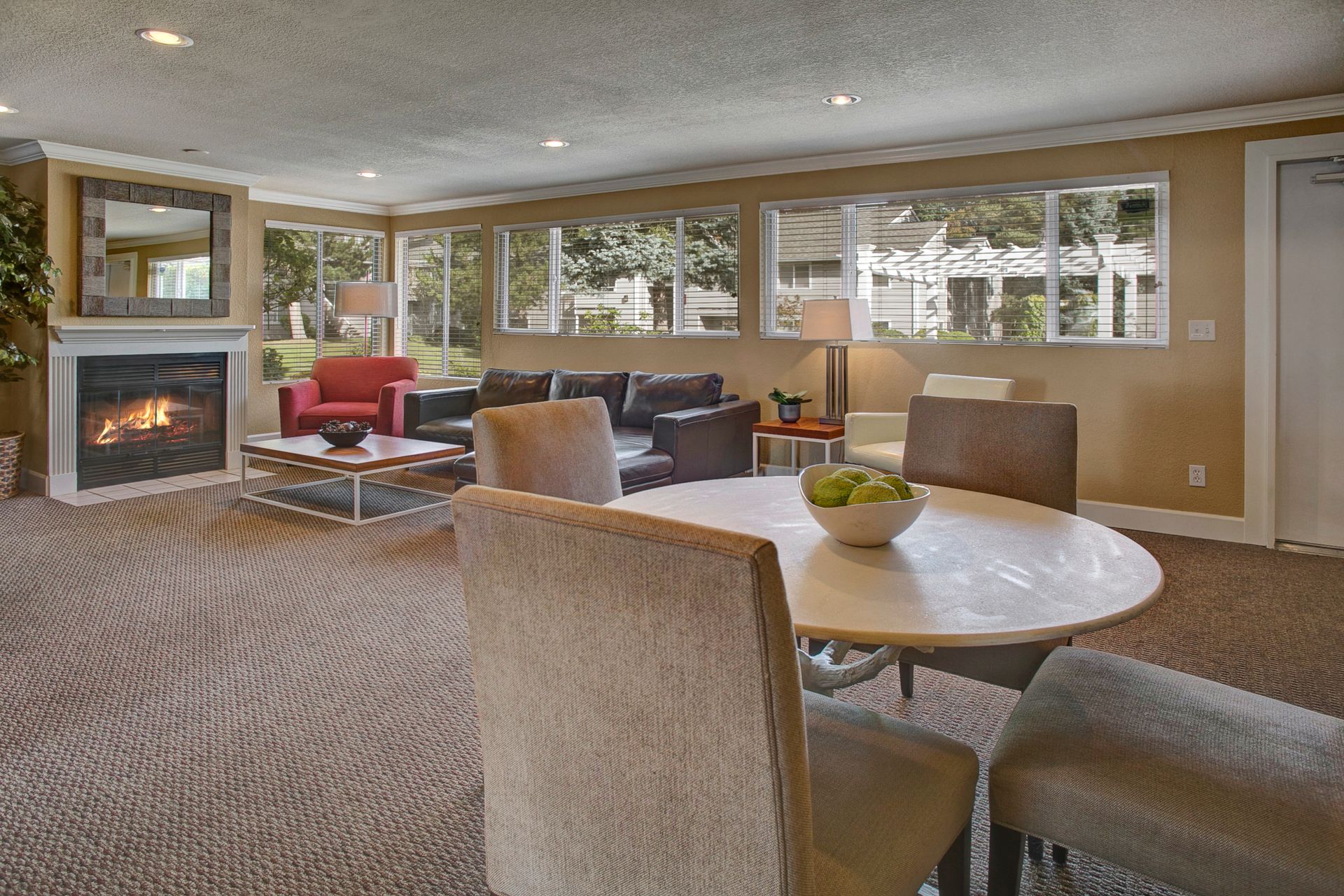 A living room with a table and chairs and a fireplace