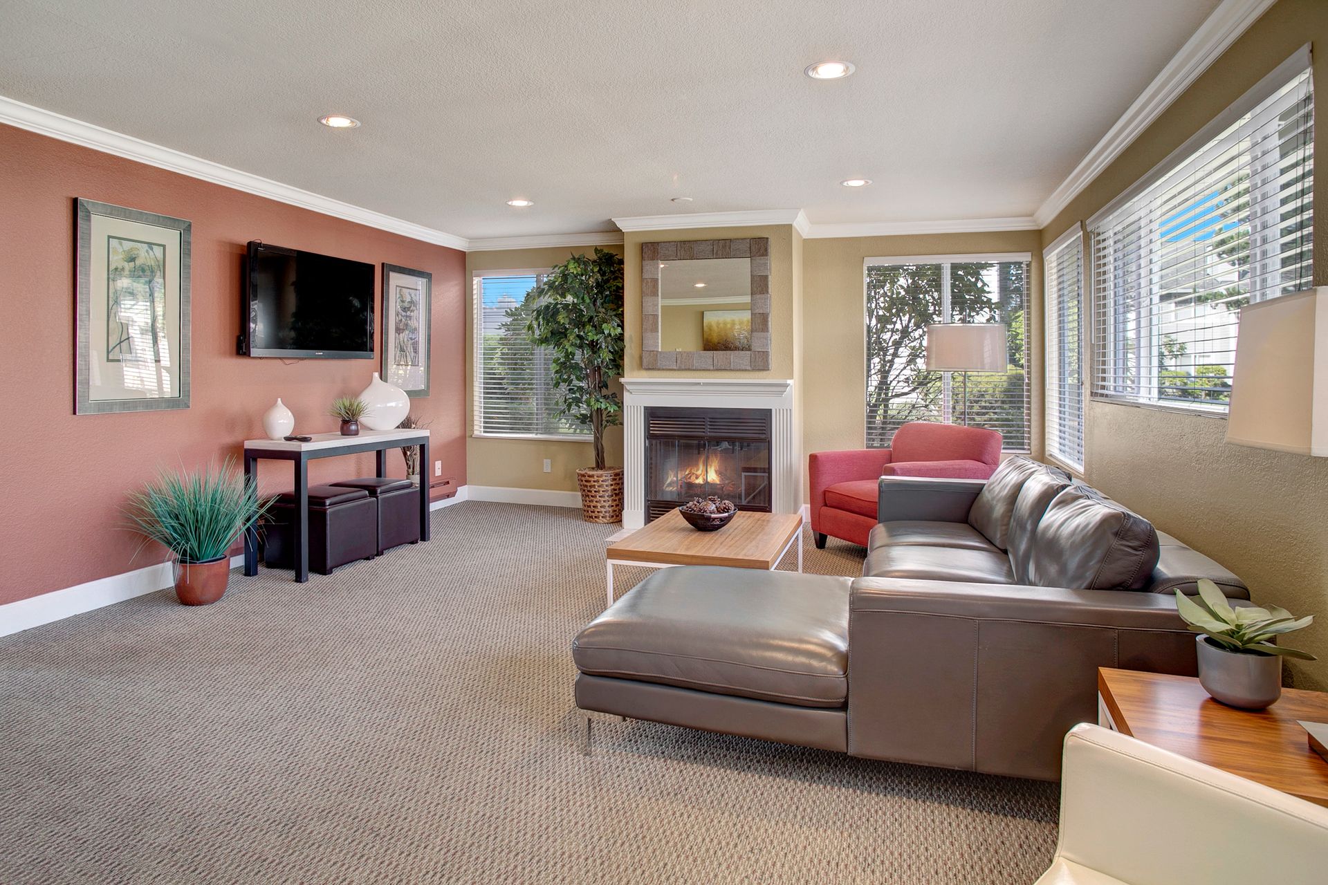 A living room with a couch , chair , table , fireplace and television.