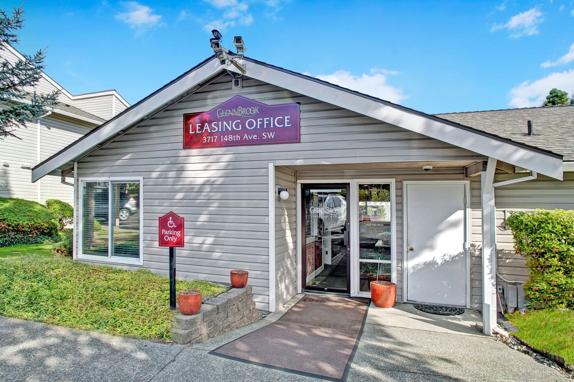 A white house with a purple sign that says post office