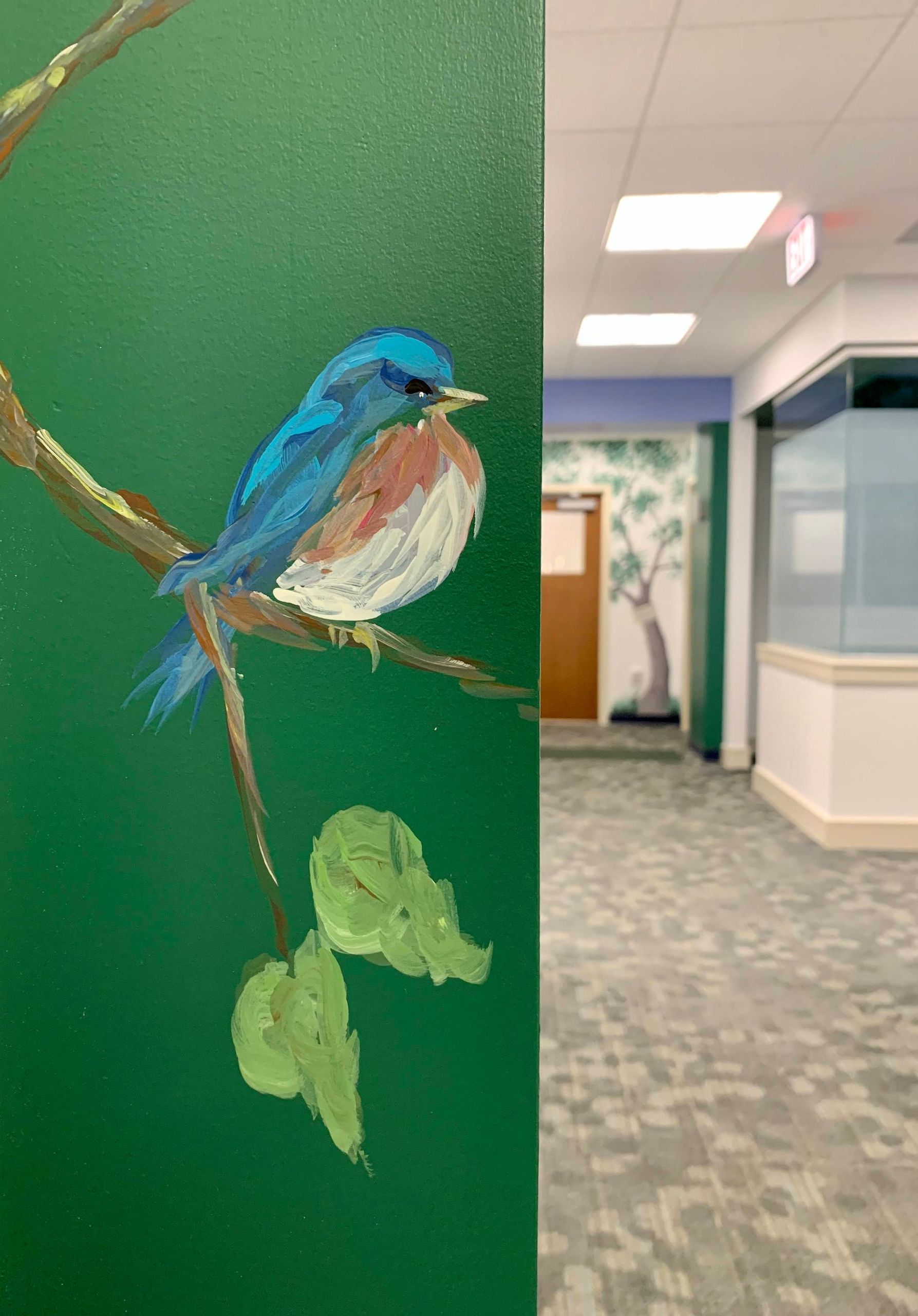 Pediatric office mural with blue bird on a branch