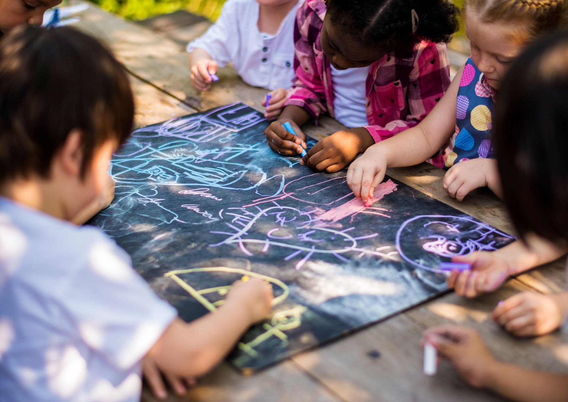 Children busily drawing with chalk
