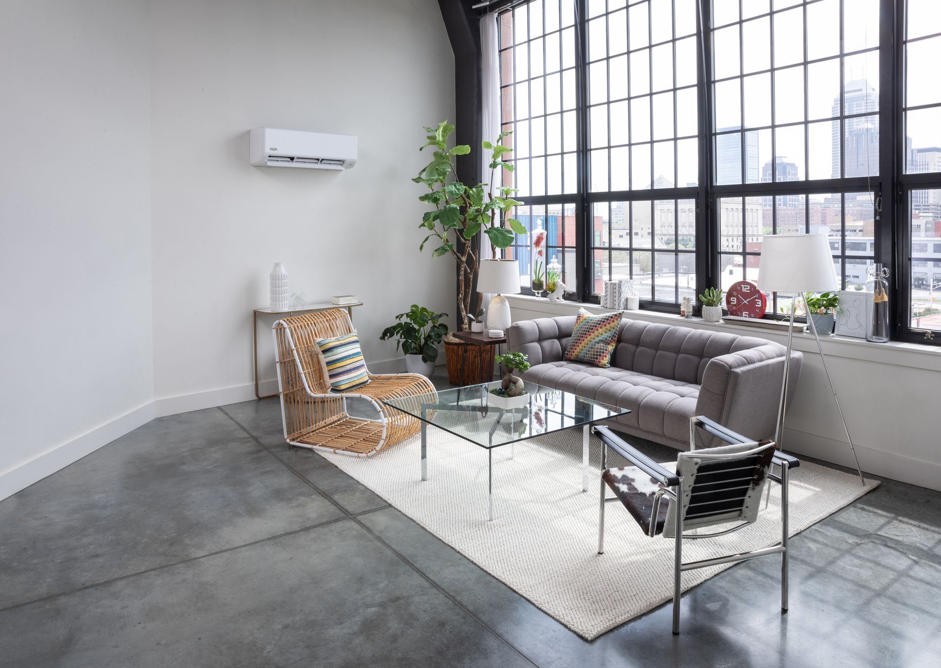 Living room with industrial windows, sofa, and modern furniture.
