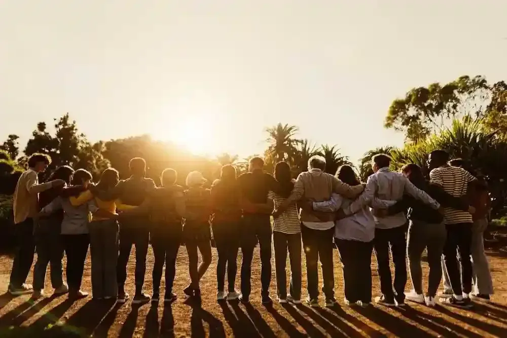 Group of people holding each other.
