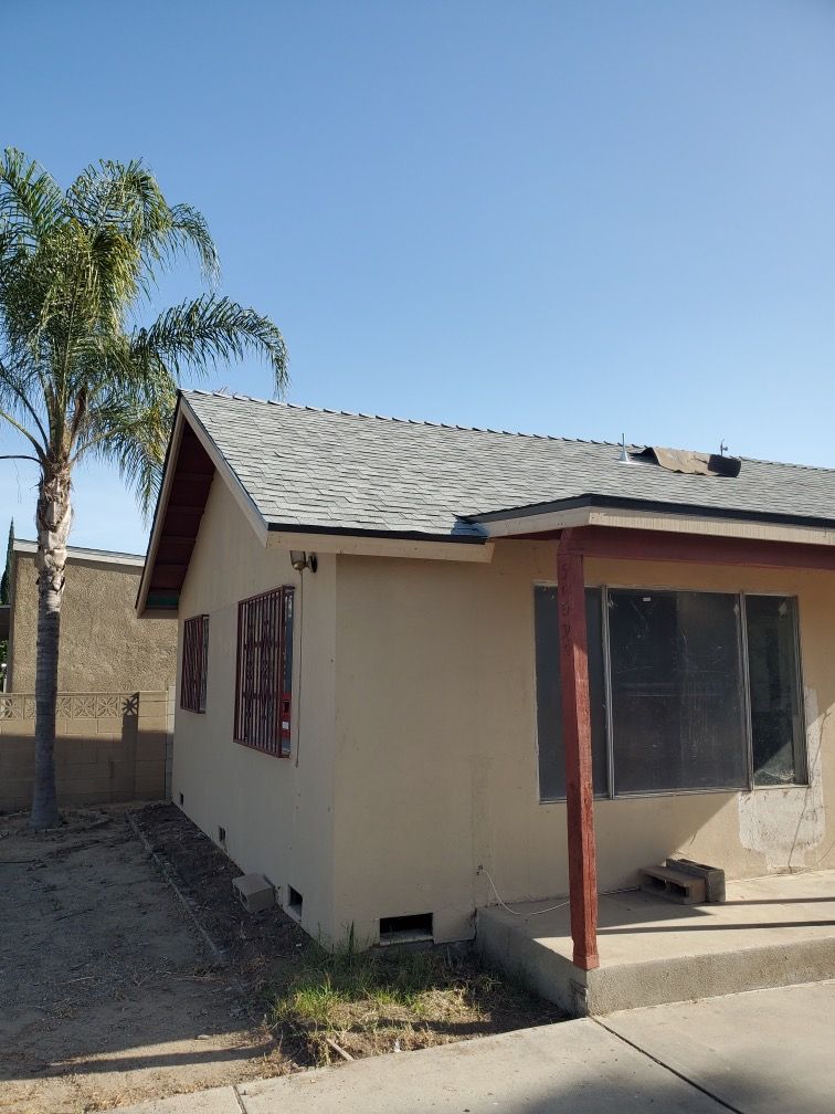 A small house with a palm tree in front of it