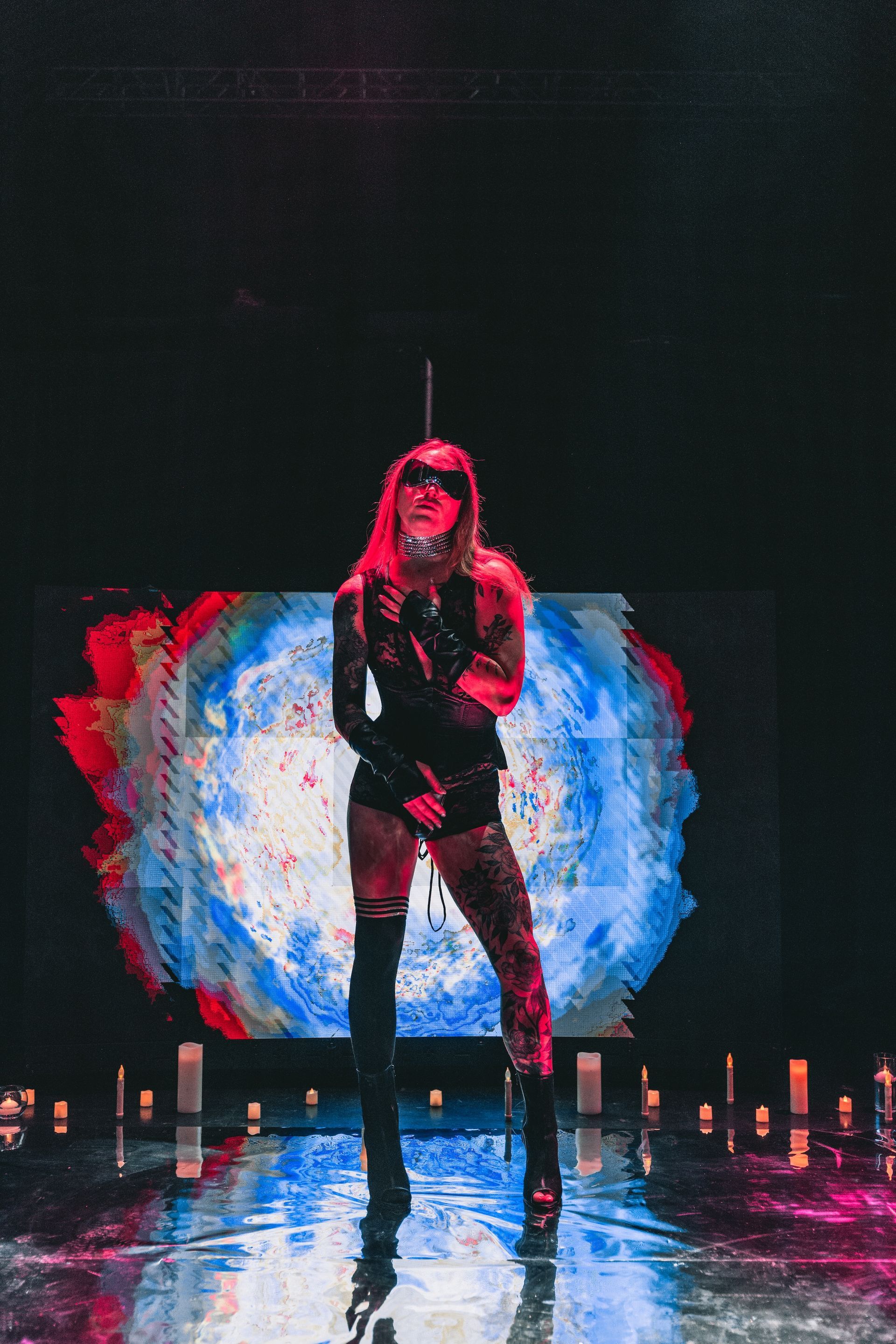 A person is posing for a photo on a fashion runway for a photoshoot in lingerie.