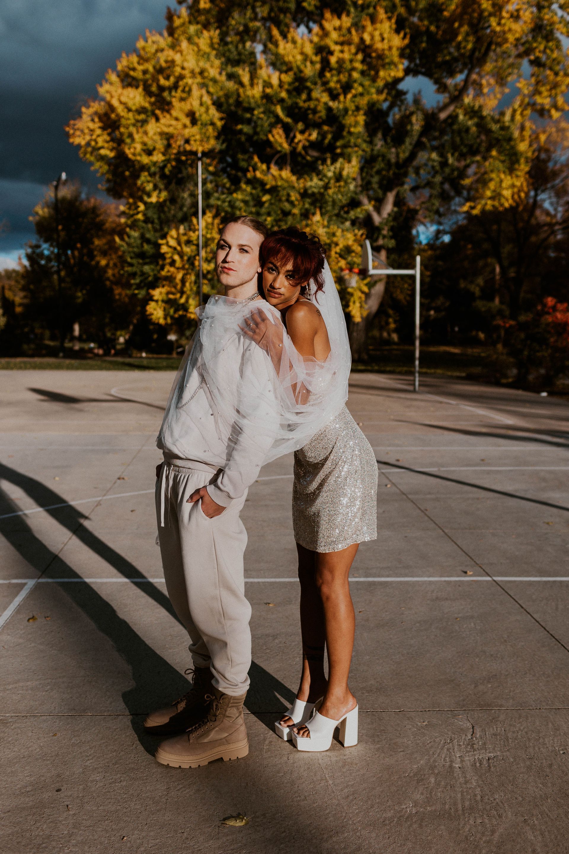 Scotty modeling for a styled shoot with a female model for a wedding photoshoot themed around basketball