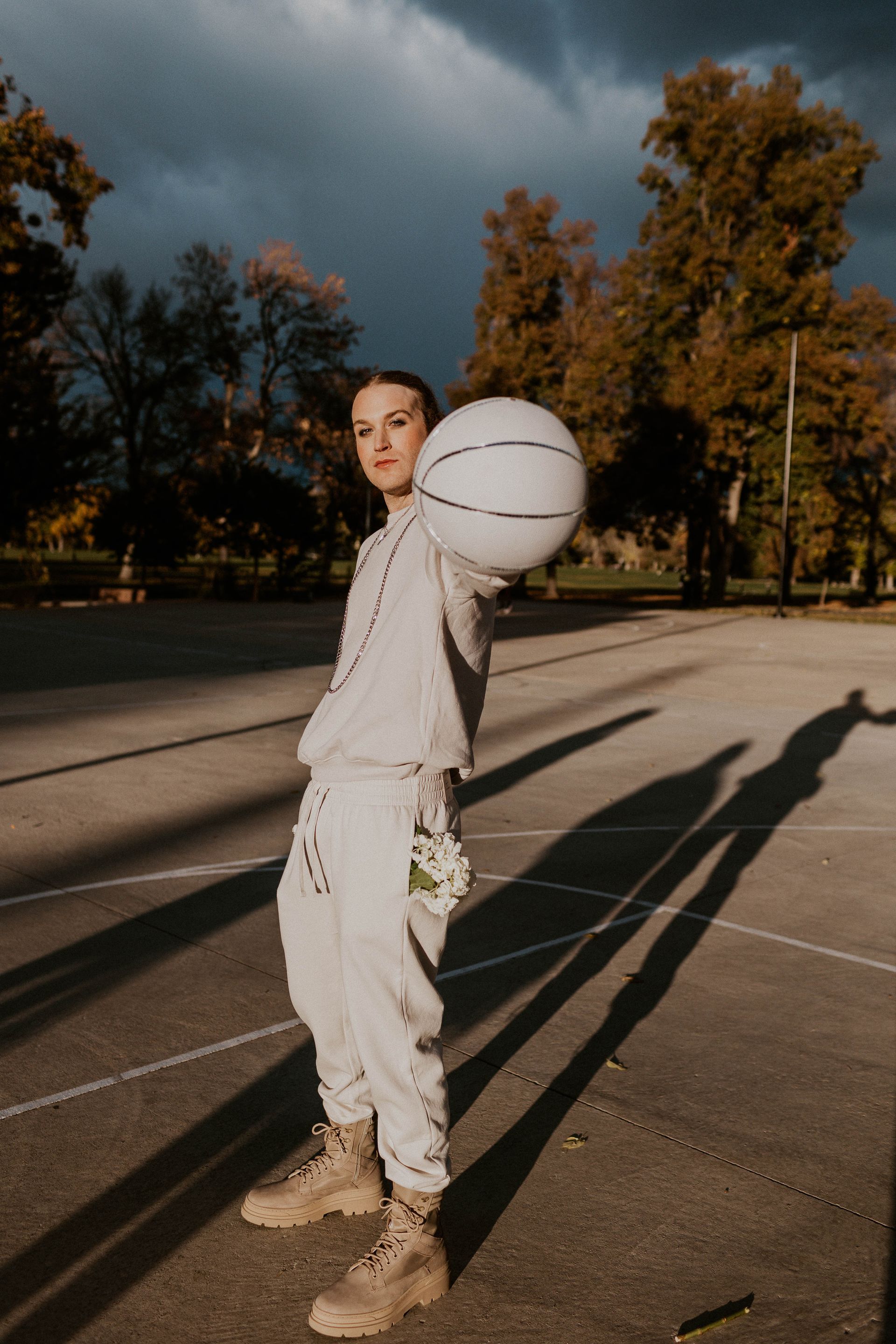 Scotty posing as a model in a photoshoot with a basketball