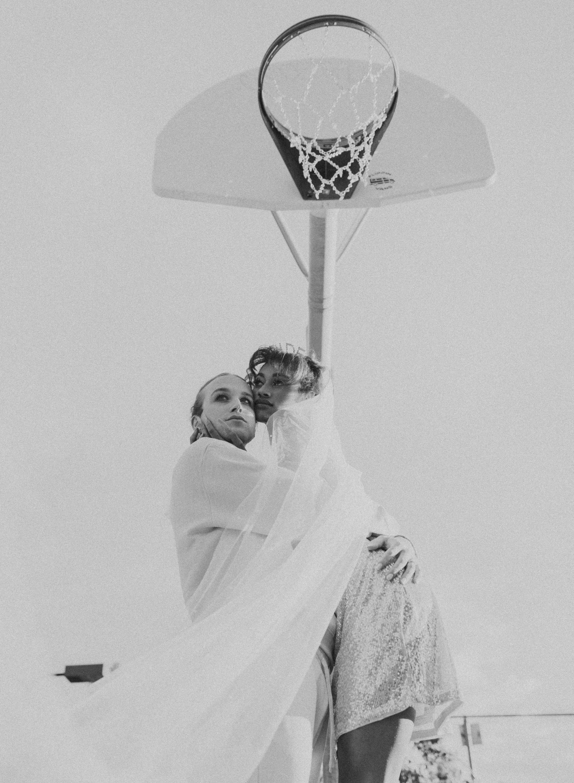 Scotty modeling for a styled shoot with a female model for a wedding photoshoot themed around basketball