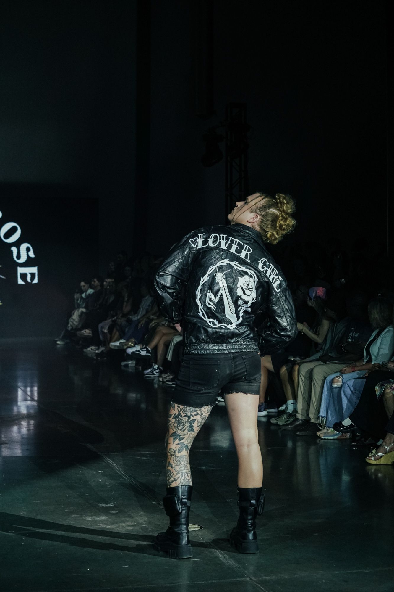 Scotty Strehlow is walking down a runway at a fashion show for Denver Fashion Week.