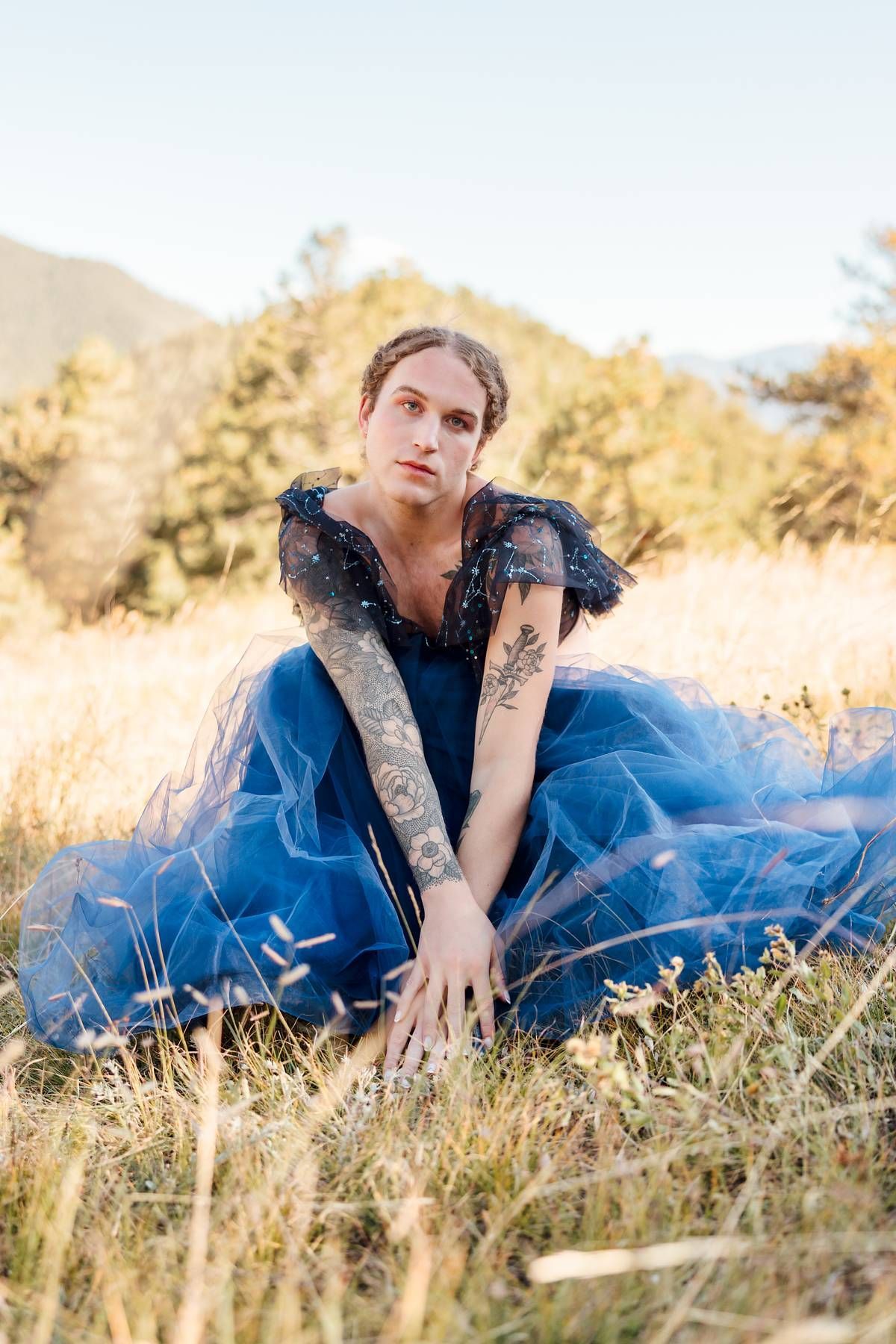 Scotty modeling outside in a tule blue dress for a photoshoot in the mountains 