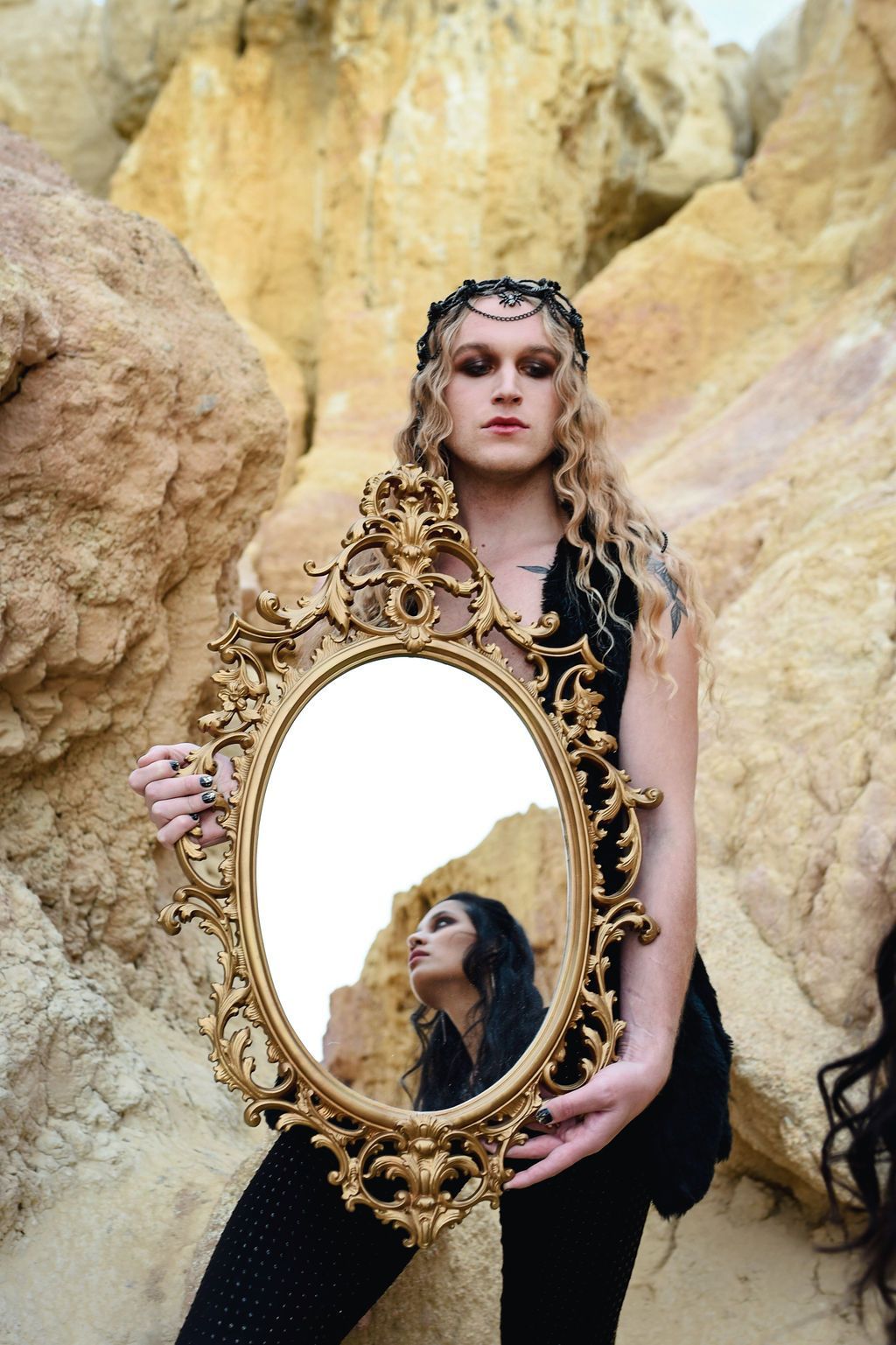 Scotty doing a model pose for a Halloween photoshoot in a cave