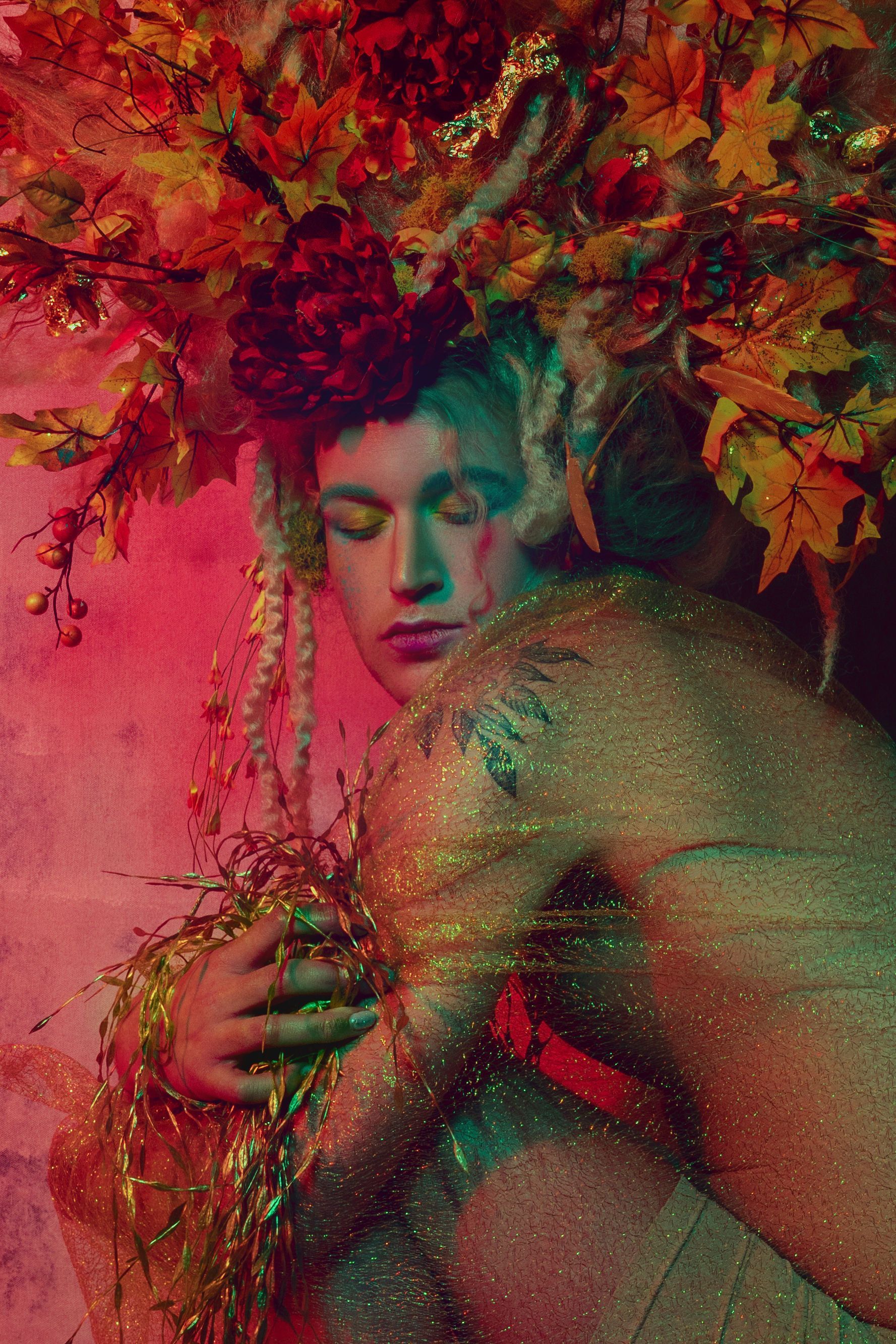 Scotty with a crown of flowers on their head for a fashion photo shoot.