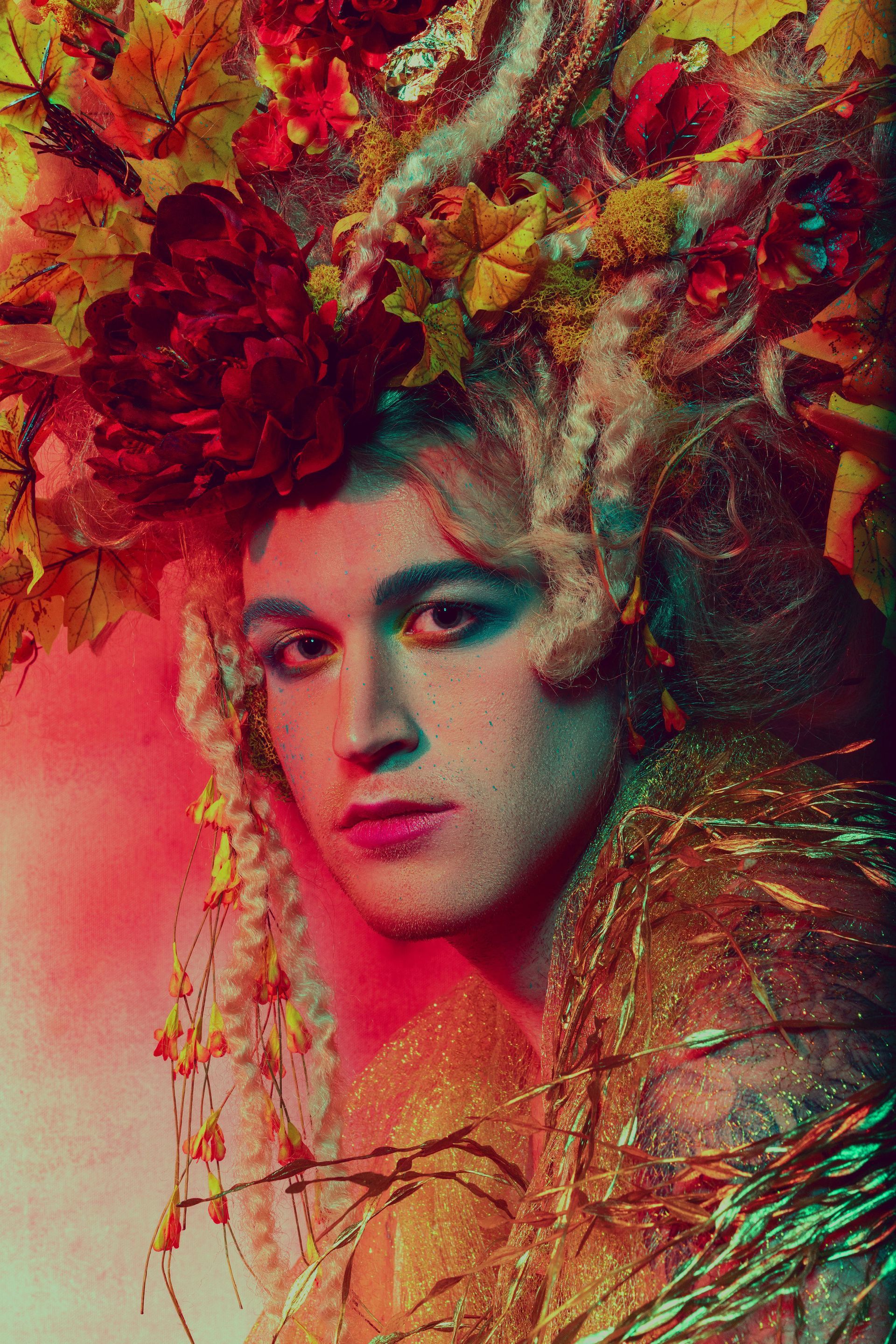 A close up of a person wearing a crown of flowers on their head for a photo shoot.
