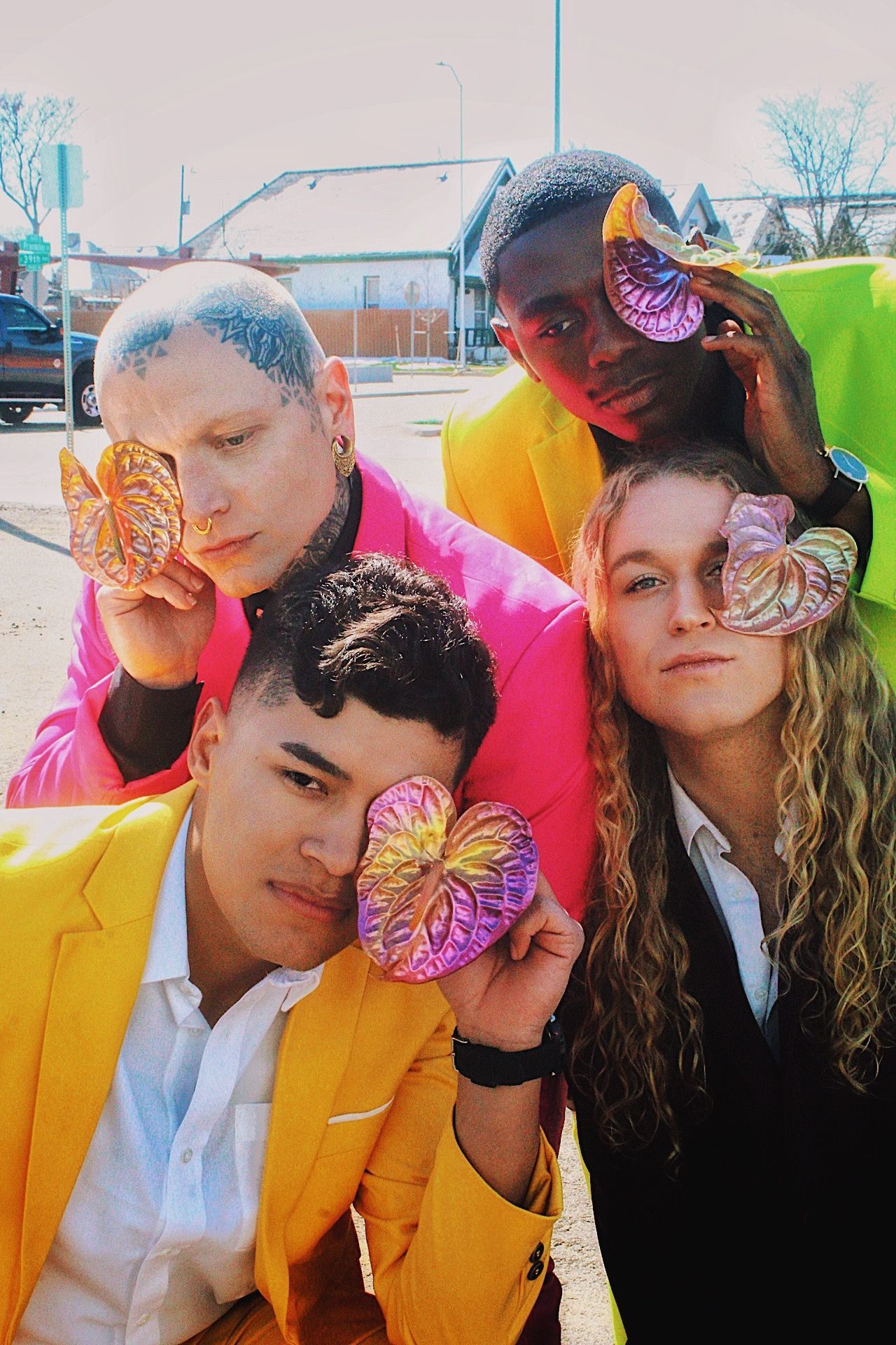 Scotty posing with other models for a colorful photoshoot of men in suits