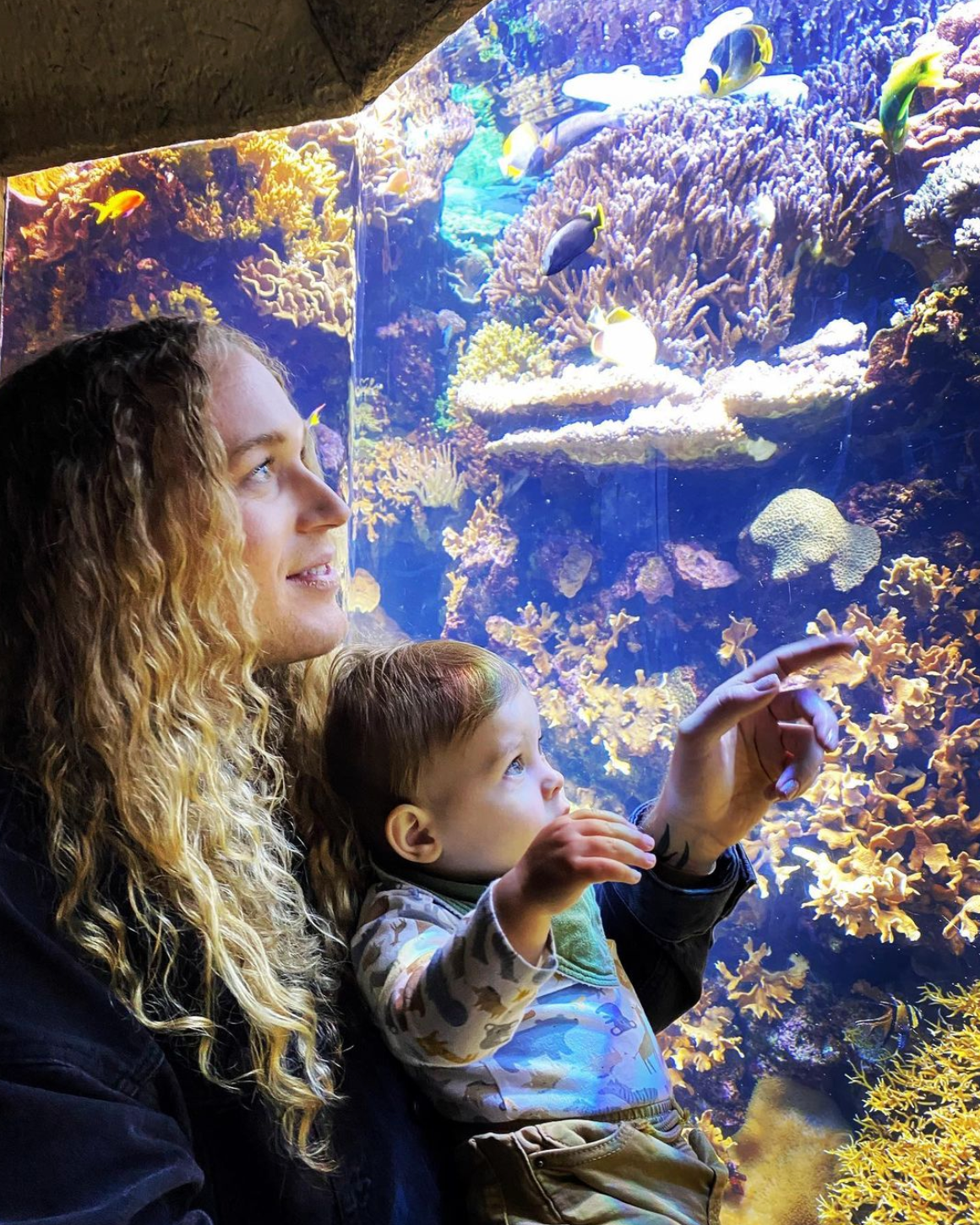 Scotty holding his nephew at an aquarium