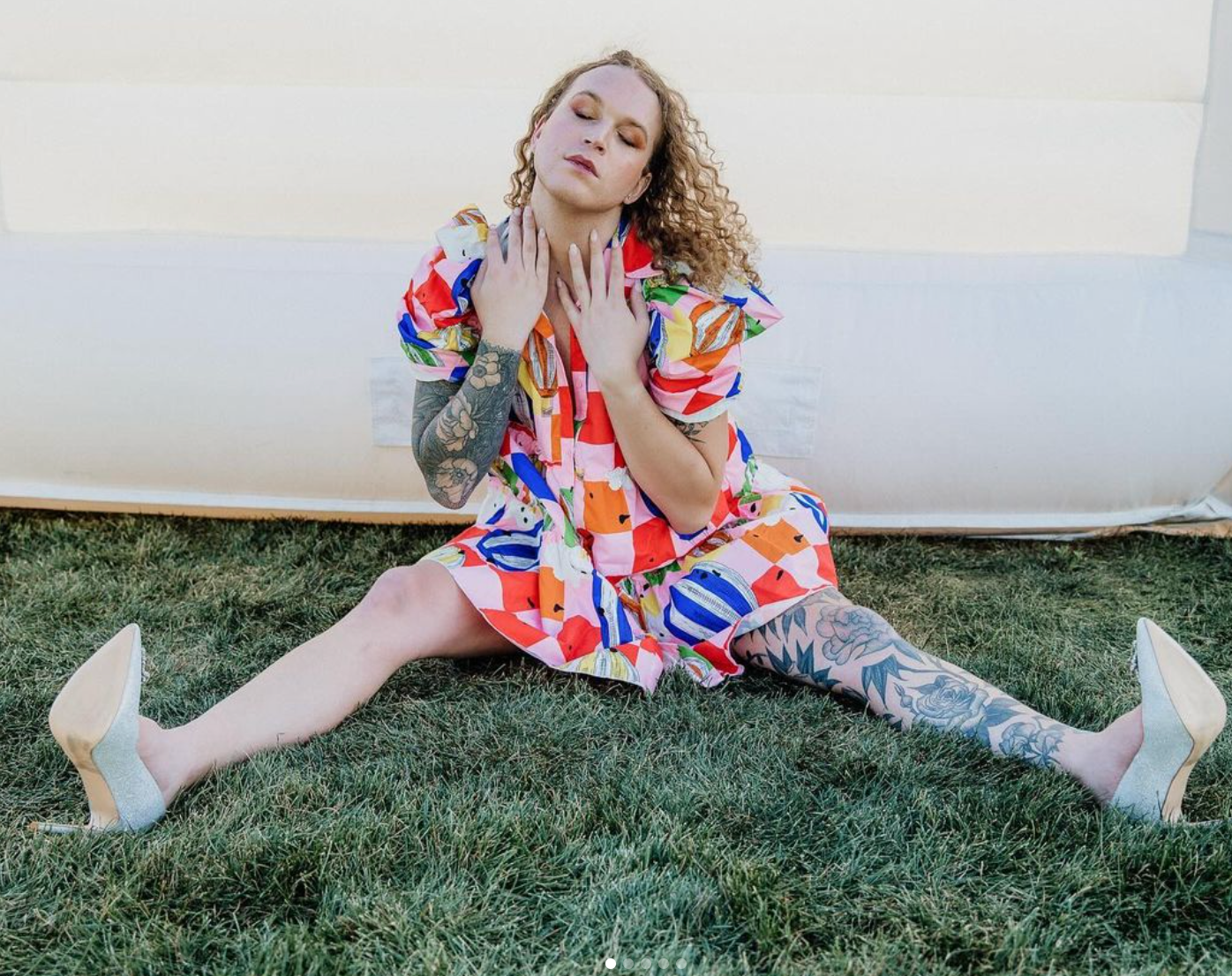 Scotty in a rainbow balloon costume modeling for a photoshoot