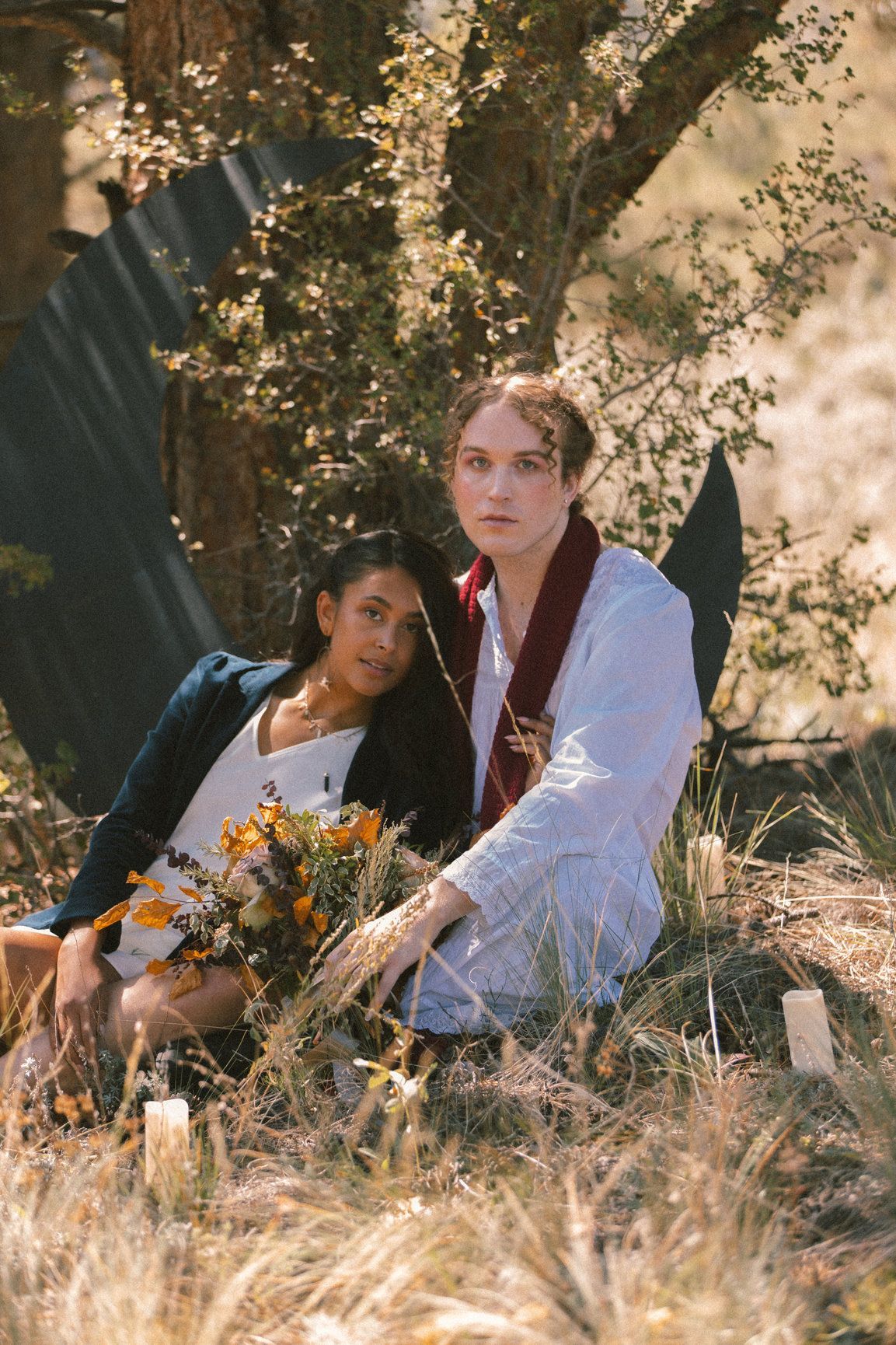 Scotty modeling  in a white night gown and red scarf for a Taylor Swift themed photoshoot