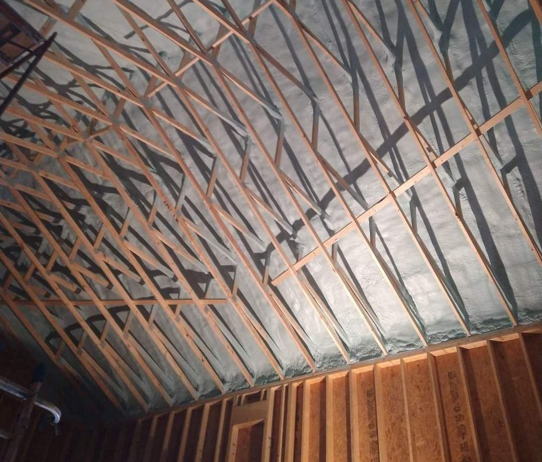 The ceiling of a building with a lot of wooden beams.