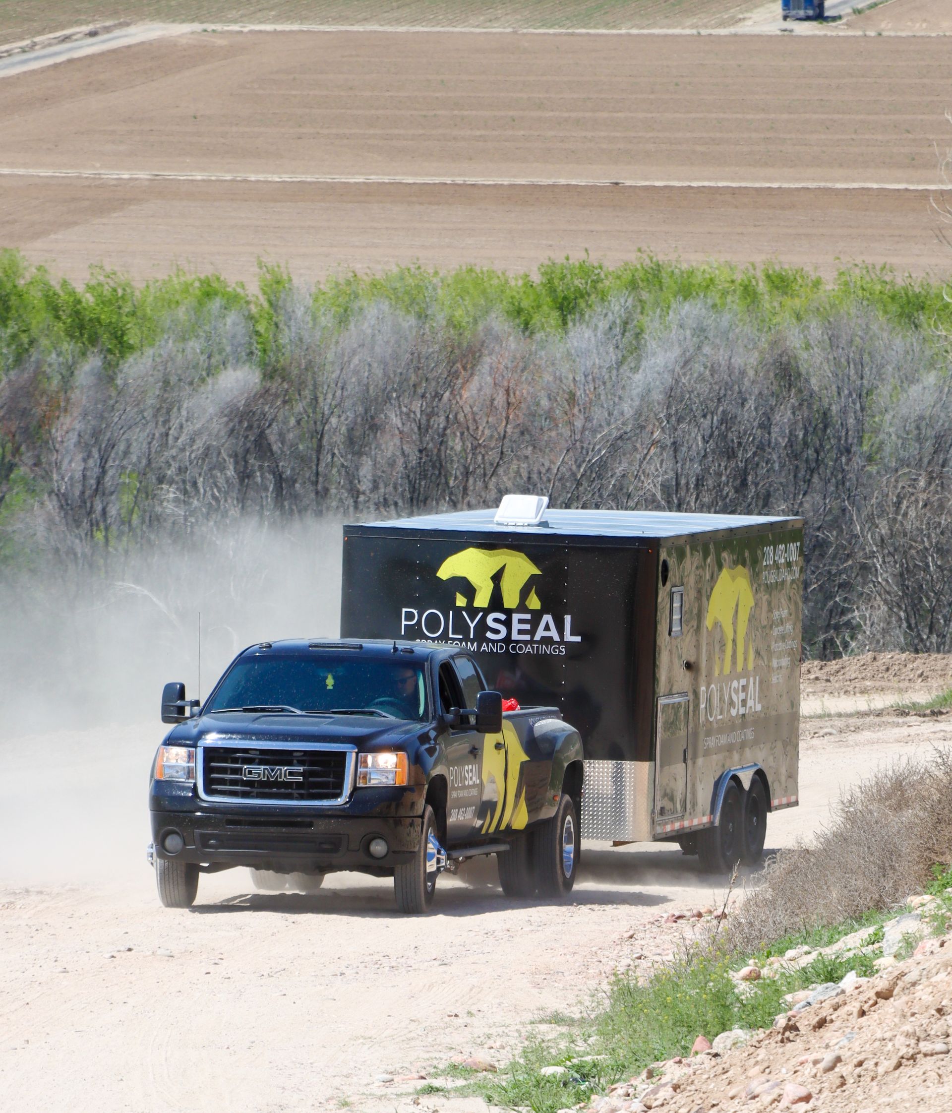 A person is spraying foam on a wooden wall.