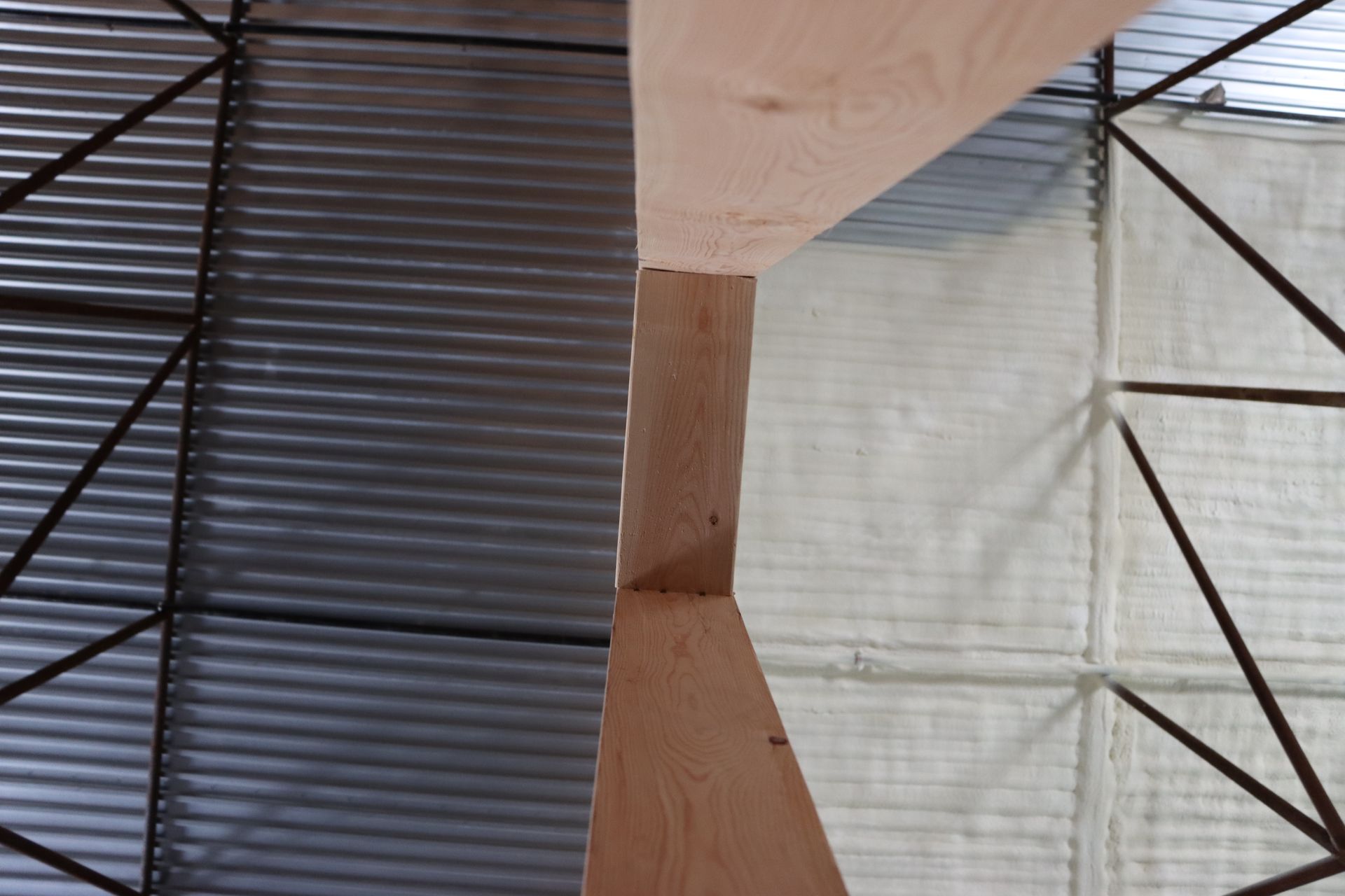 A concrete wall is being built in a dirt field.