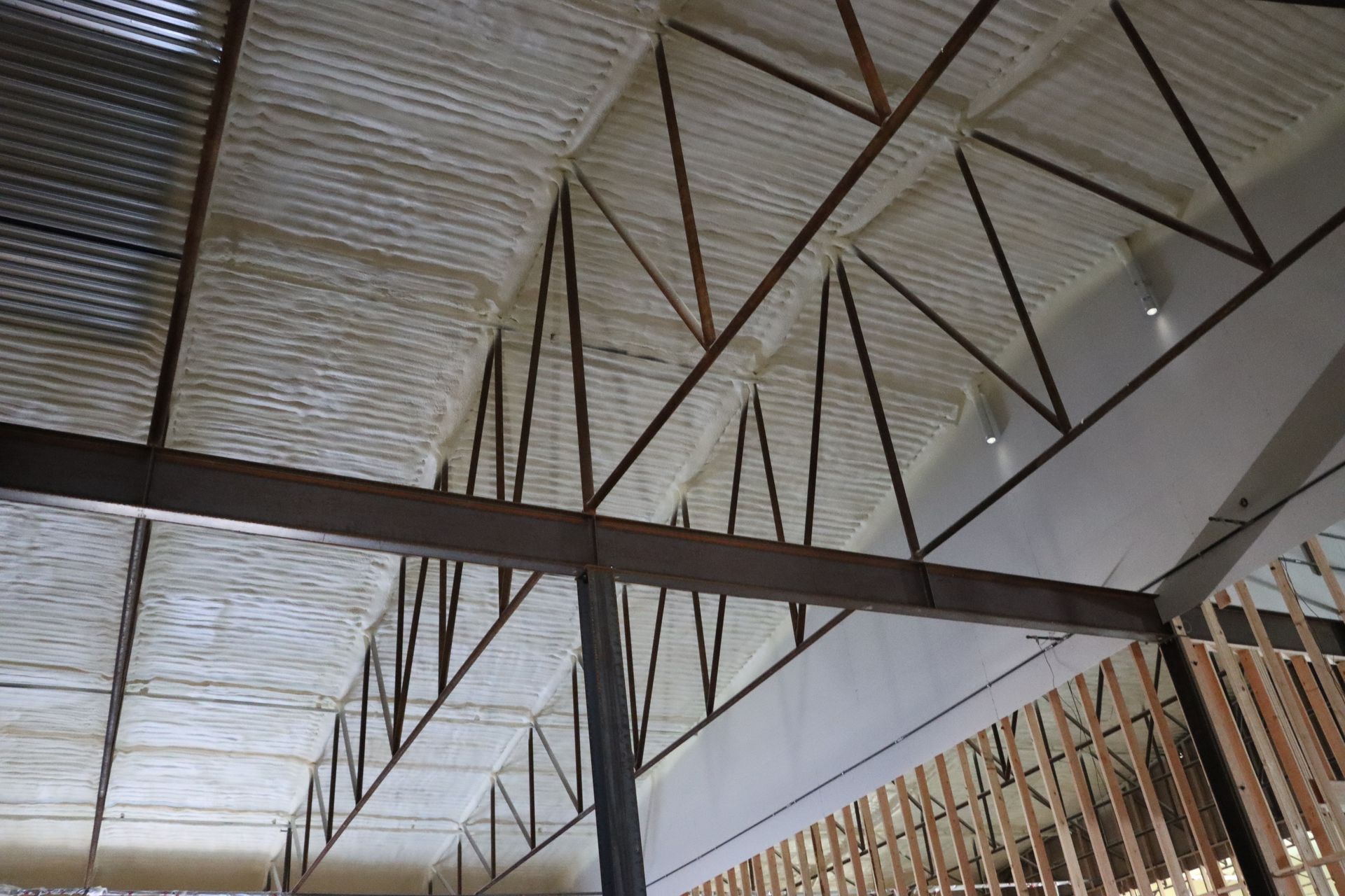 A white trailer with a lot of hose attached to it.