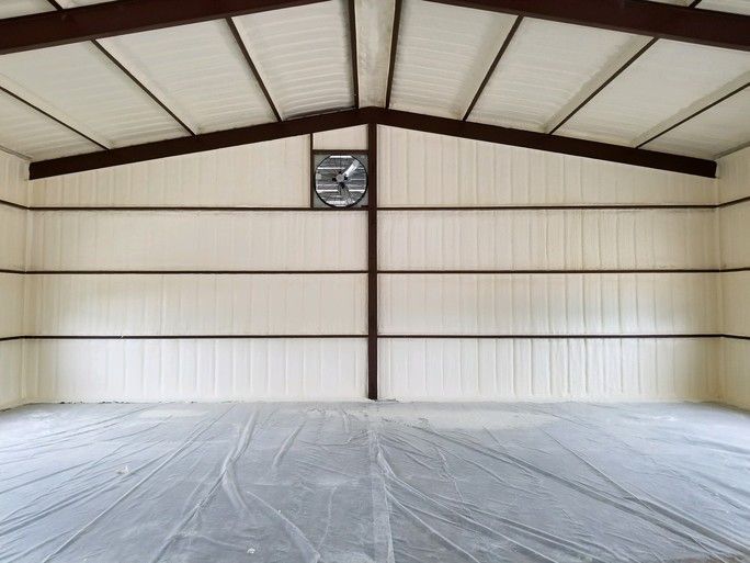 A large empty building with a fan on the ceiling.