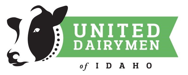 The logo for united dairymen of idaho has a cow on it