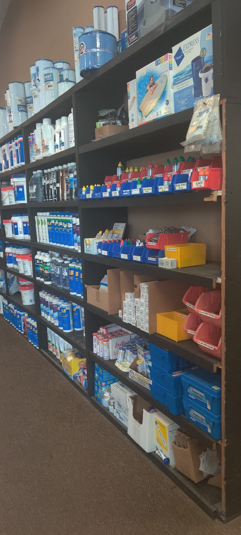 Shelves stocked with various packaged items in a store setting.