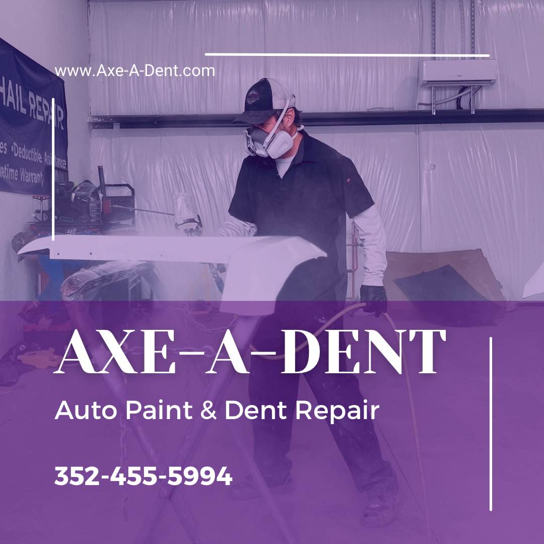 Man spraying paint on a car part inside a shop. 