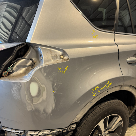 Damaged silver SUV rear quarter panel, showing body repair work, including a dent | Axe-A-Dent Auto Collision