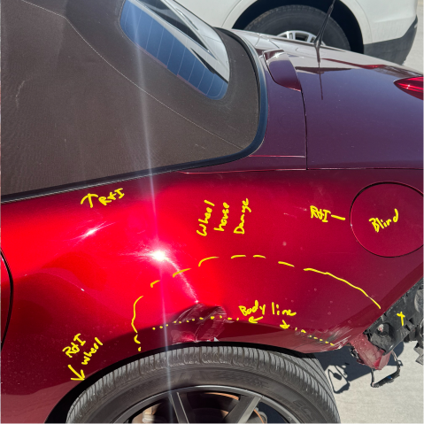 Damaged red convertible car rear quarter panel. Yellow arrows highlight body damage and wheel | Axe-A-Dent Auto Collision