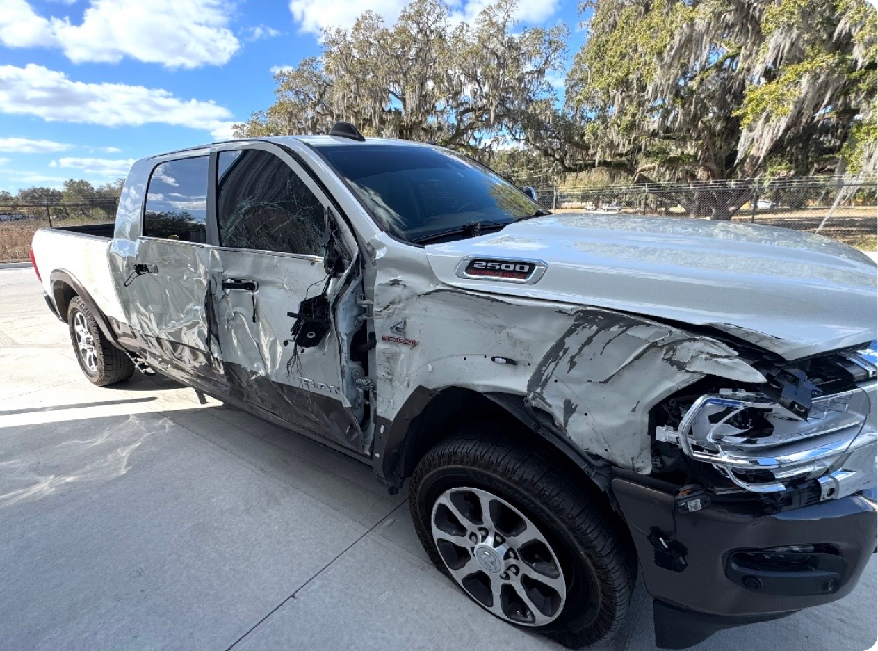 Red pickup truck parked inside a metal building | Axe-A-Dent Auto Collision
