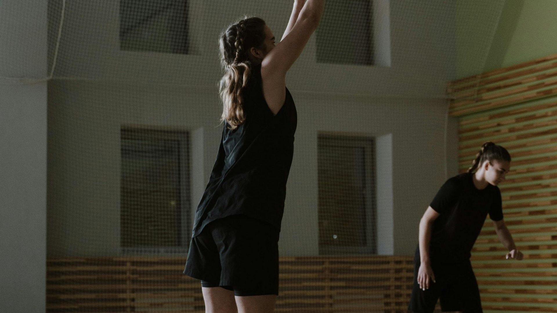 Youth basketball player shooting in a gym, representing how purposeful training builds confidence an