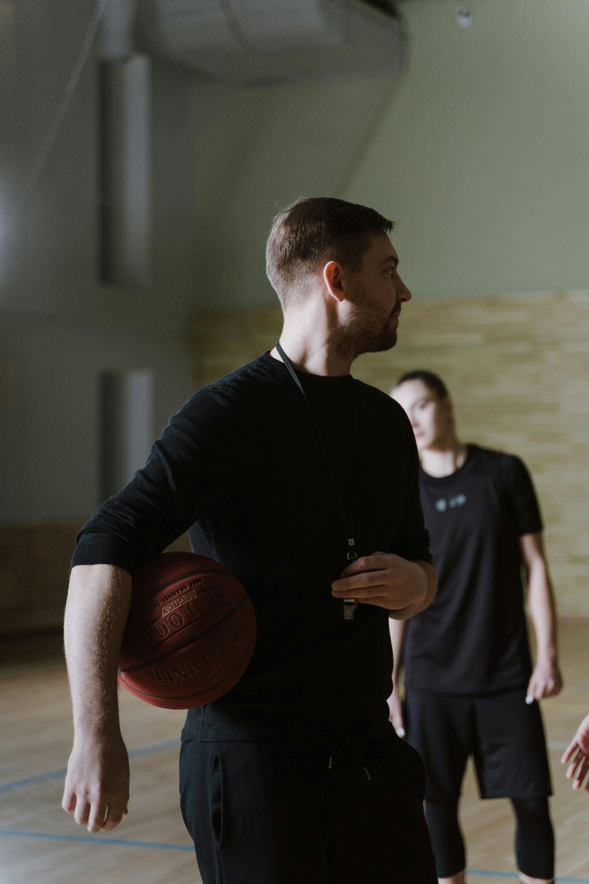Basketball player training on court—focused skill development, coaching, and confidence building dur