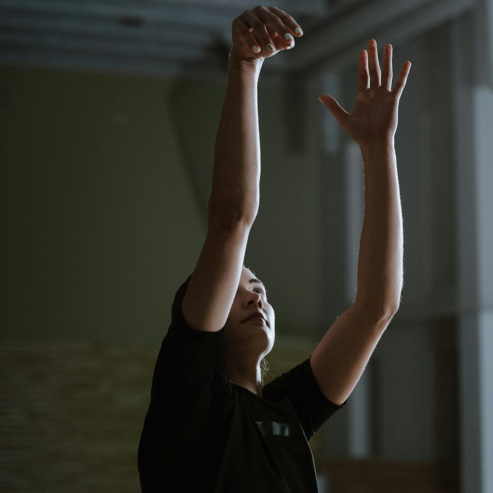 Youth basketball player training fundamentals in an empty gym, representing skill development, work