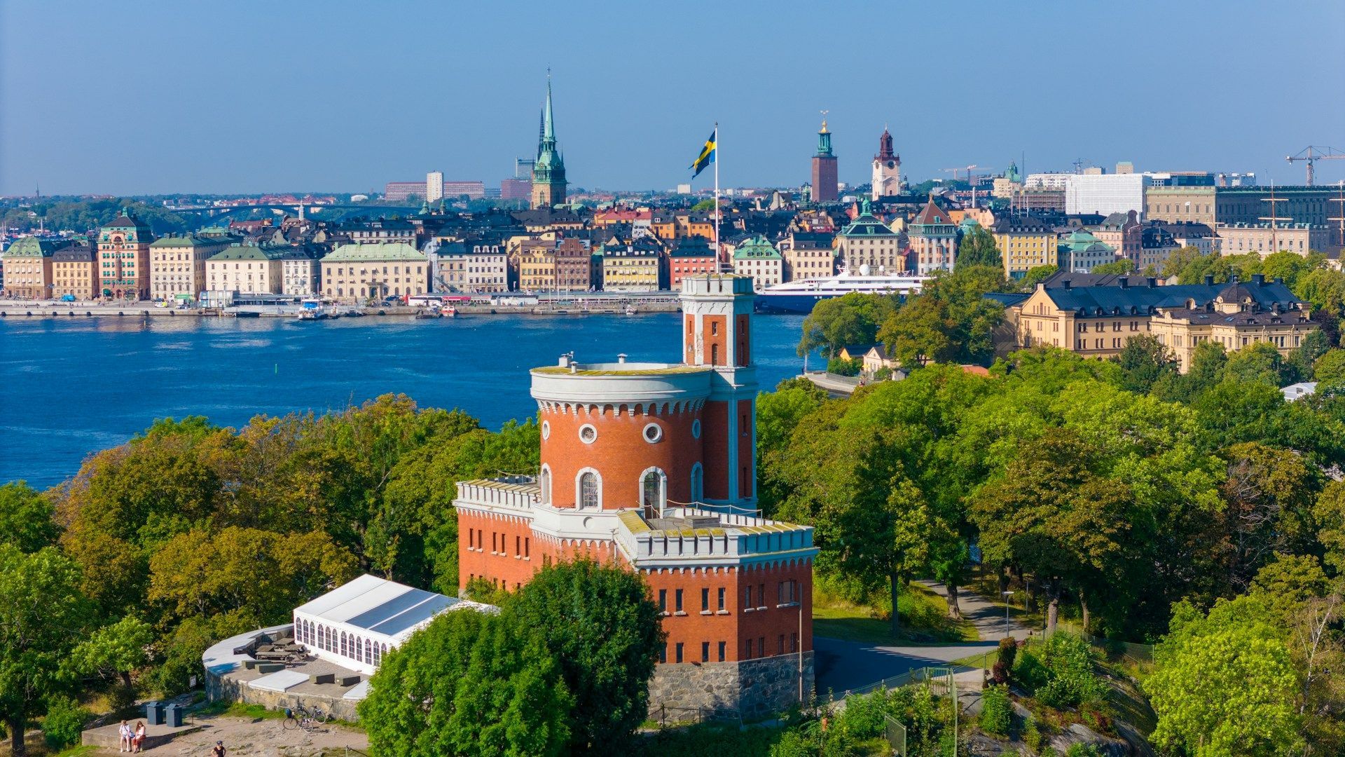 Kastellholmen tower in Stockholm, Sweden, overlooking the water with the city skyline in the background.