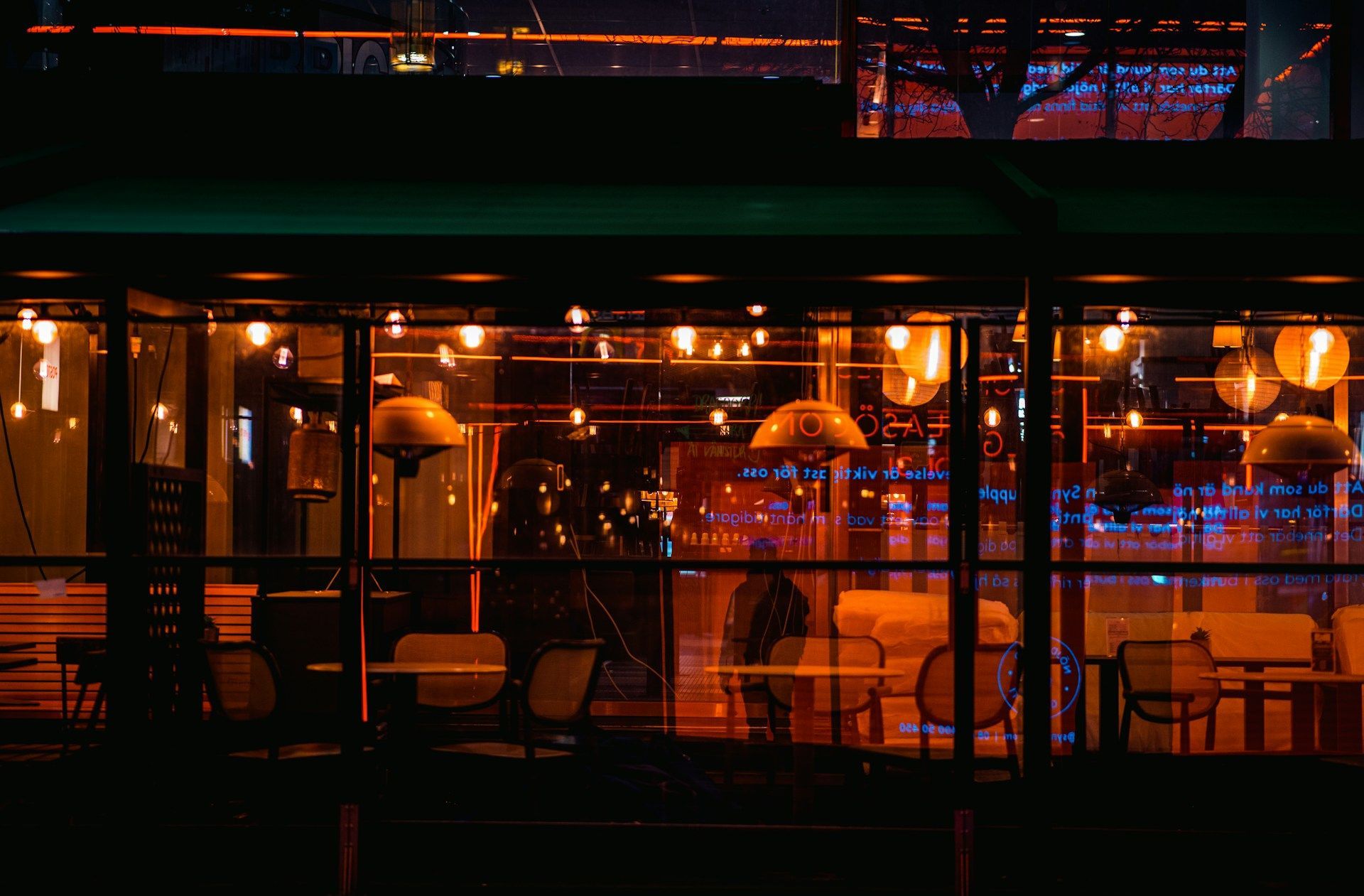 A softly lit outdoor restaurant patio at night in Stockholm.