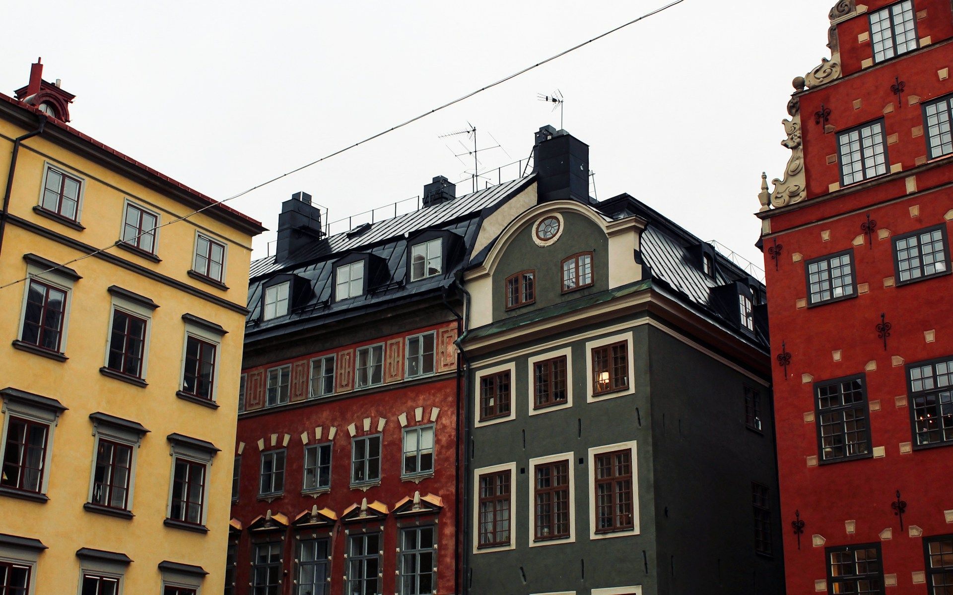 A row of narrow, colorful historical buildings in Stockholm's Old Town.