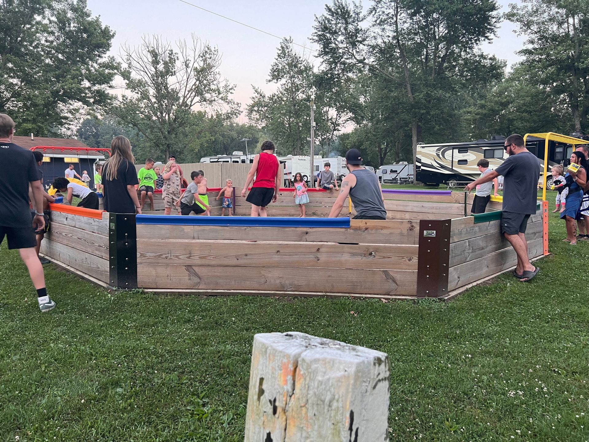 A group of people are playing a game of soccer in a park.